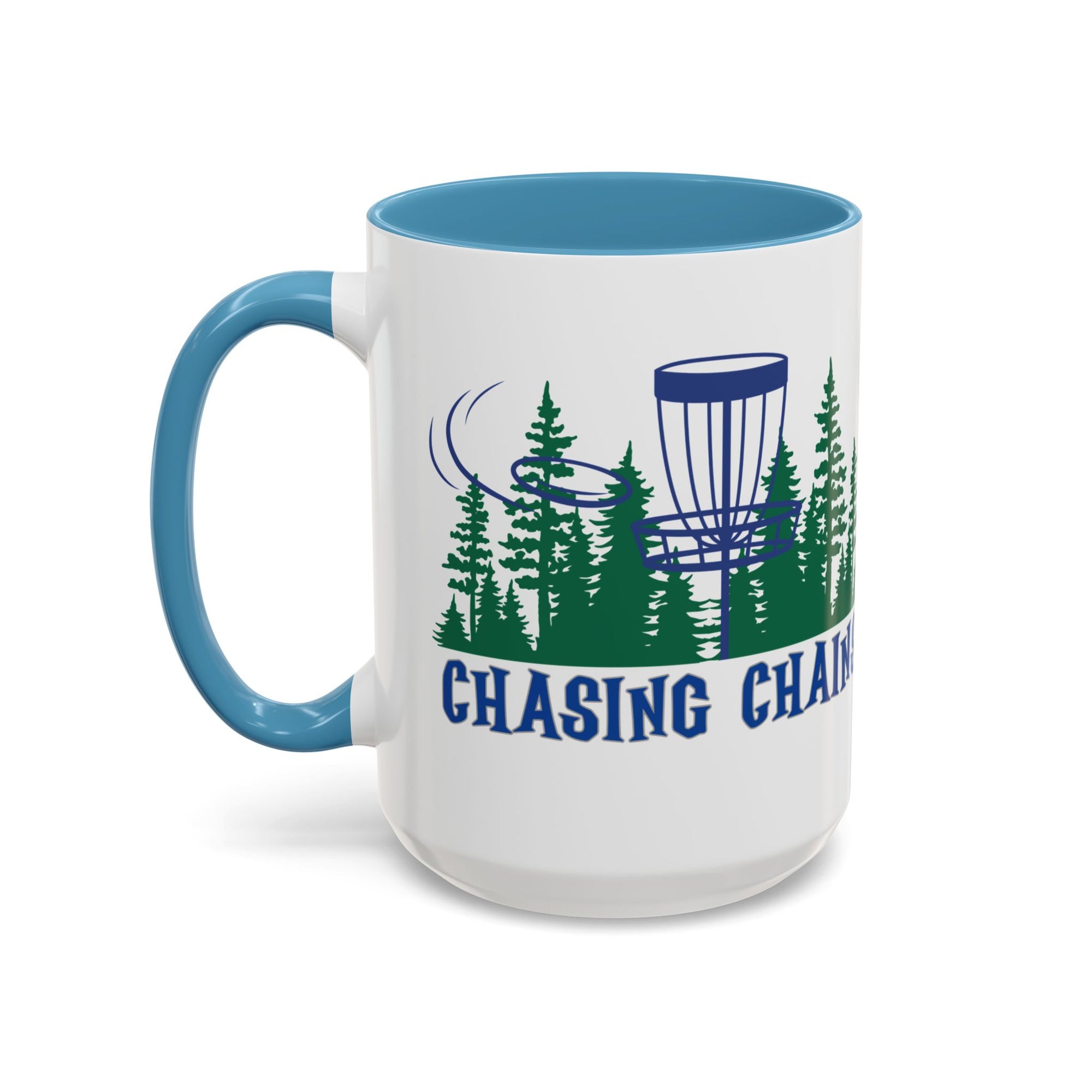 A ceramic coffee mug with light blue accents on the handle and interior, with 'Chasing Chains' graphic featuring a flying disc golf disc and basket and chains in front of a scenic evergreen tree landscape, against a white background