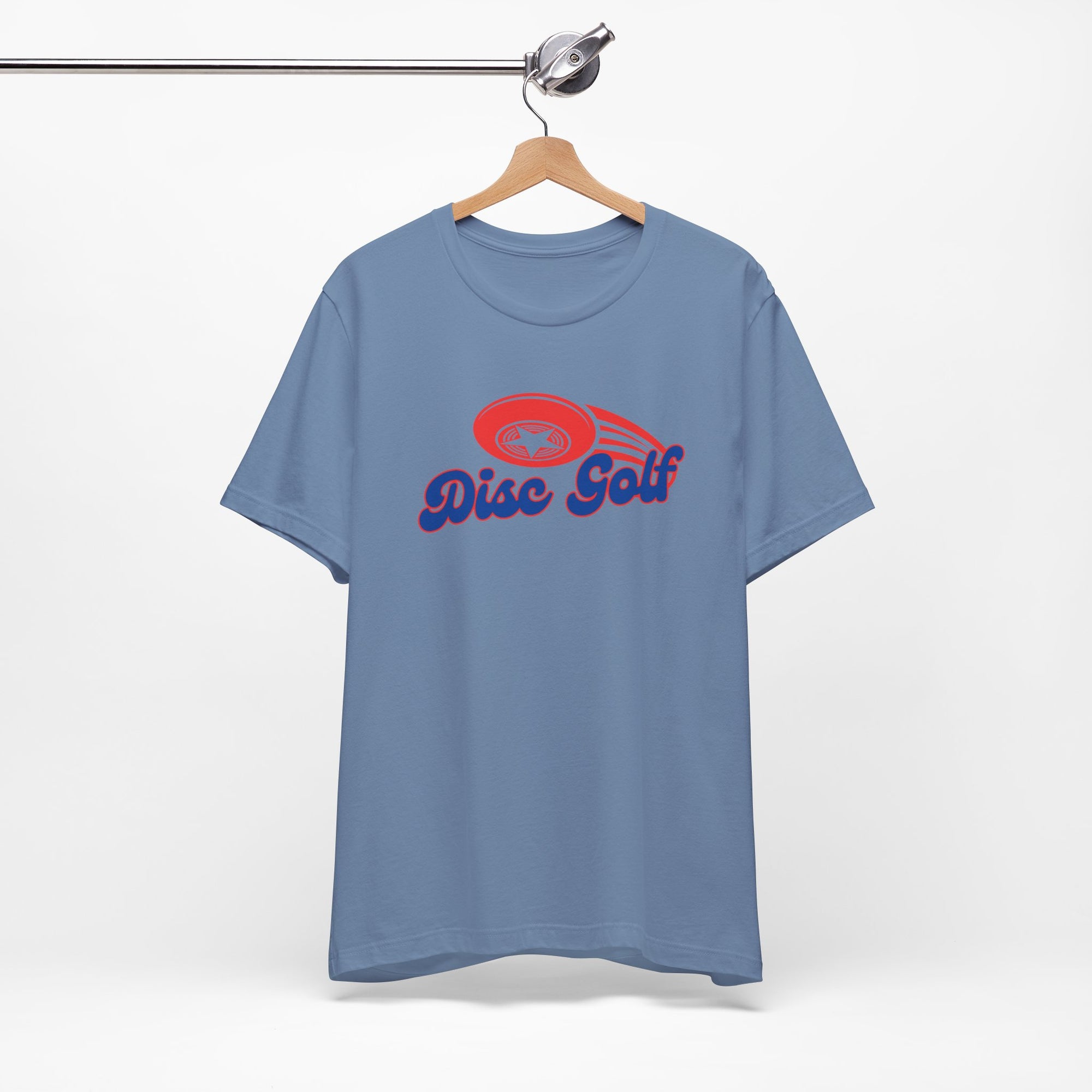 Cobalt blue t-shirt with 'Disc Golf' in a blue script text outlined in red and disc golf with motion trails, on a hanger against a white background