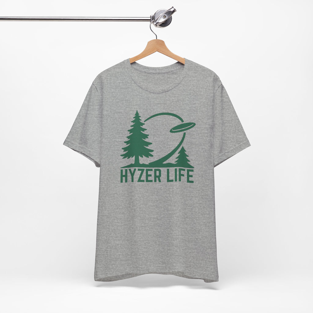 Gray t-shirt with green graphic of trees and a disc golf flying with the words 'HYZER LIFE' below the image, on a hanger against a white backgroud