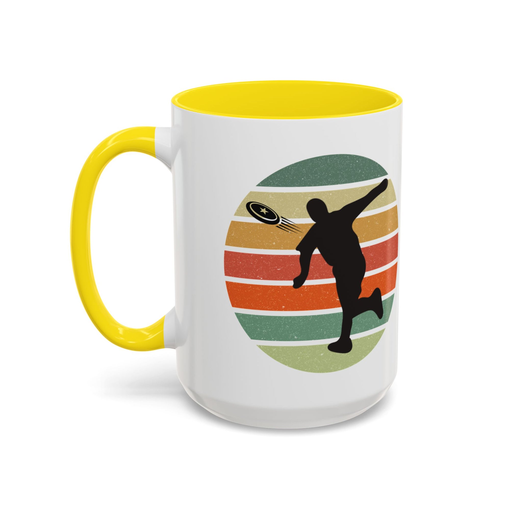 White ceramic coffee mug with yellow accents on the handle and inside. The mug features a graphic of a silhouette of a disc golf player above a colorful retro design.