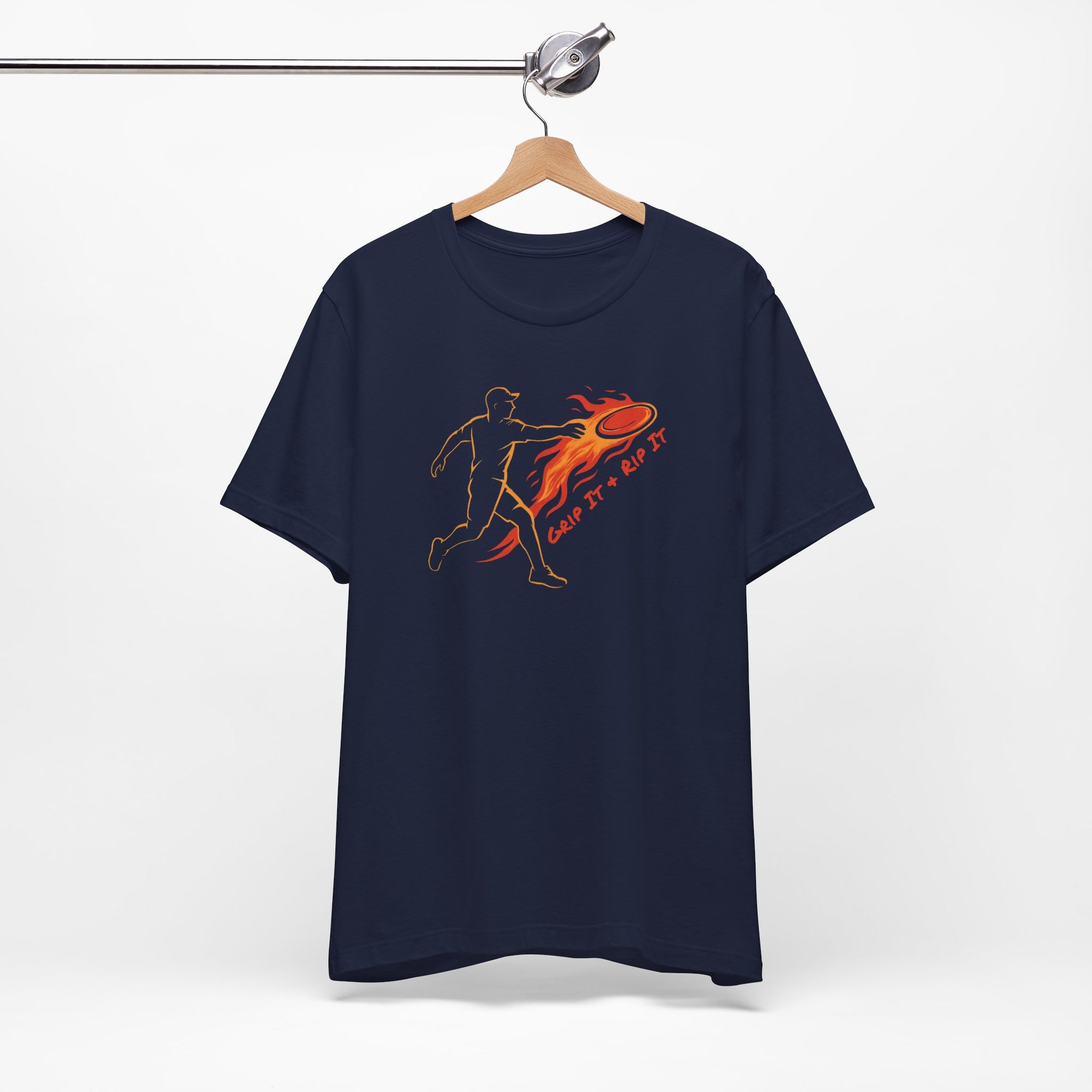 Navy blue t-shirt with a graphic design of a person throwing a disc golf disc with flames coming off the disc and text 'Grip It or Rip It' on a hanger against a white background.