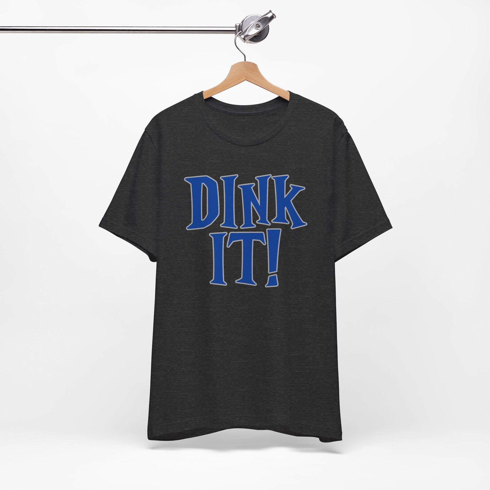 Dark gray t-shirt with 'DINK IT!' text in blue and outlined in gray, on a hanger against a white background