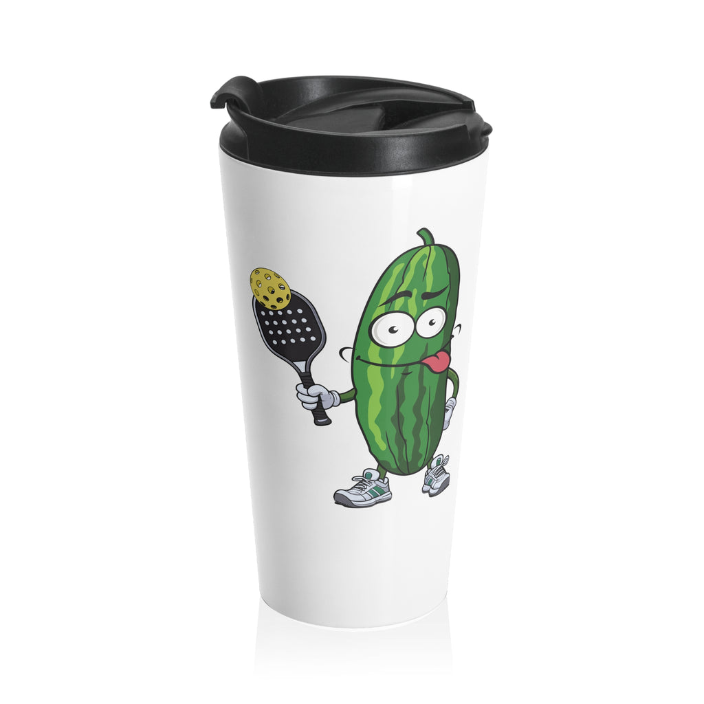 A white travel coffee mug with lid featuring a cartoon pickle with googly eyes and his tongue sticking out, holding a pickleball paddle with a yellow pickleball, against a white background