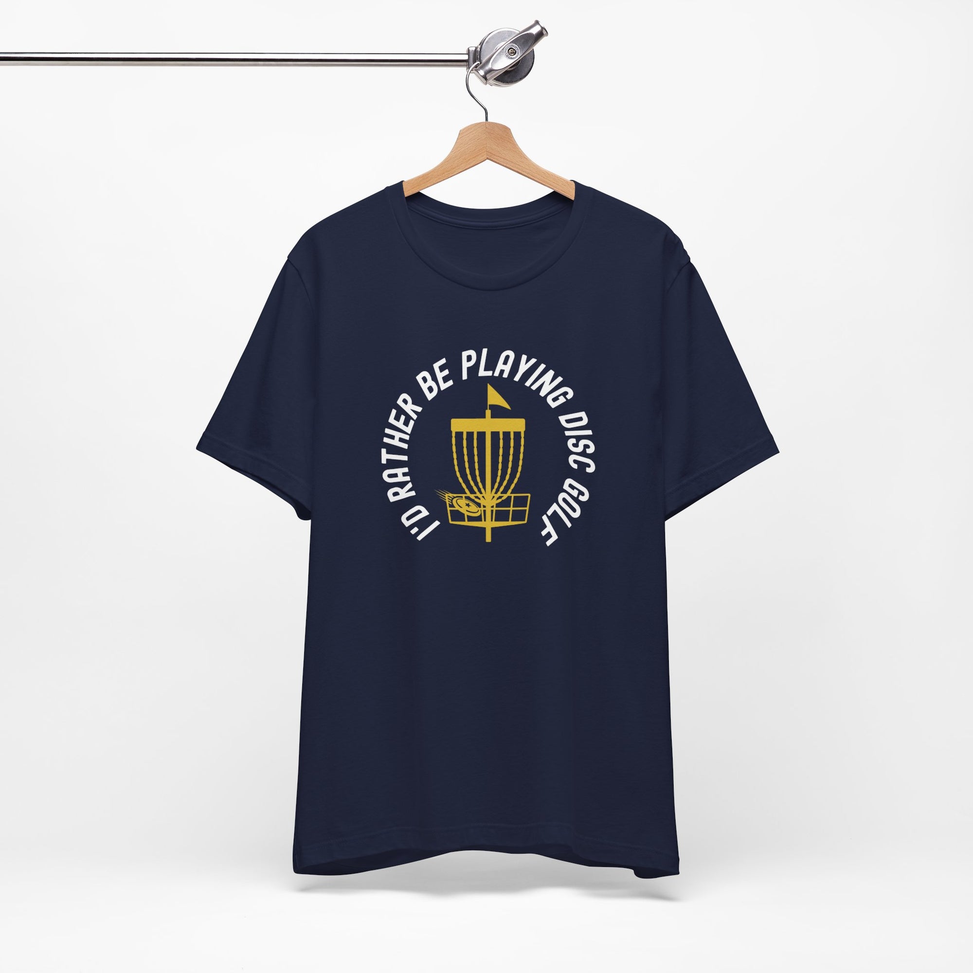 Navy blue t-shirt with a graphic of disc golf chains, basket, and disc and text that says "I'd Rather Be Playing Disc Golf" on a hanger against a white background