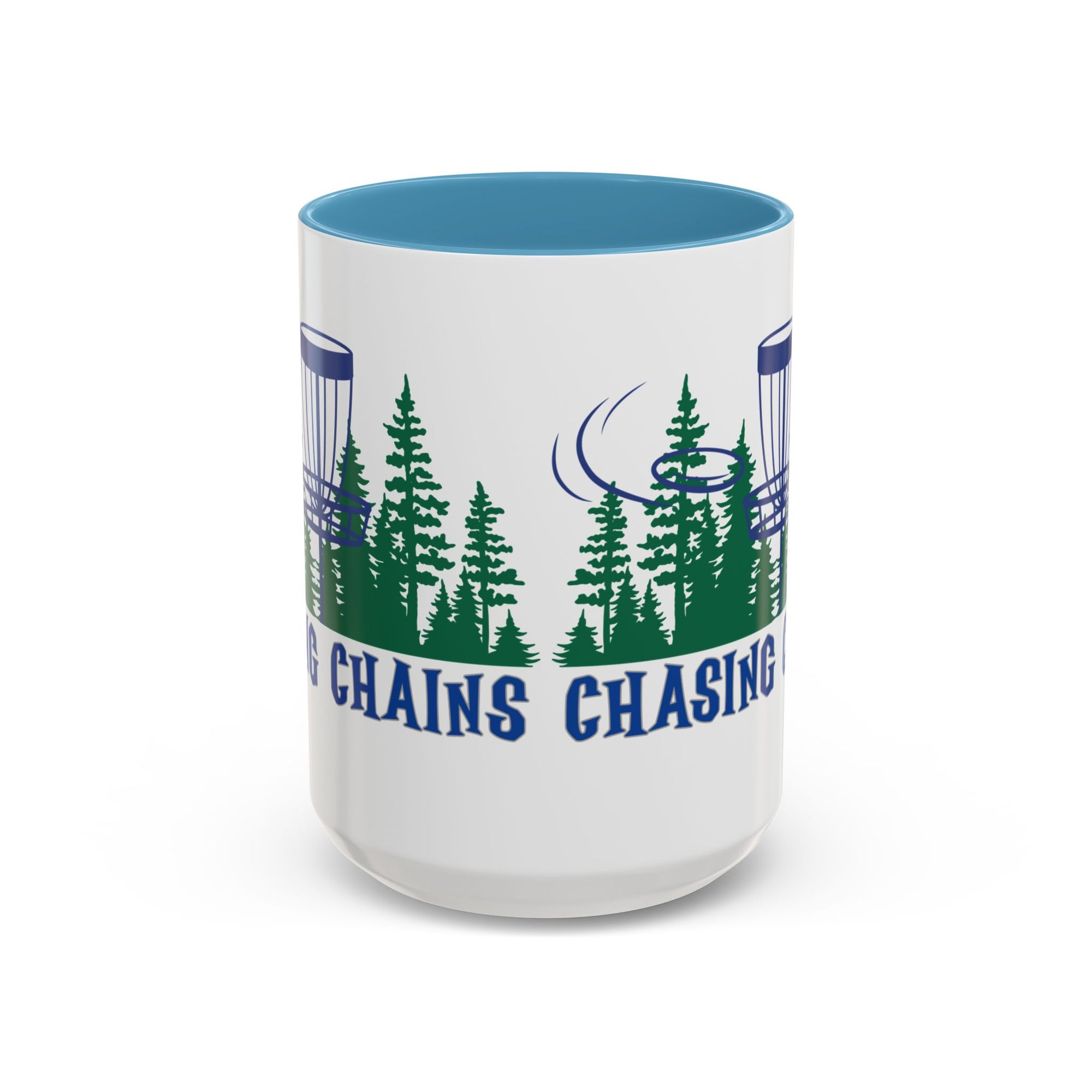 Front view of a ceramic coffee mug with blue accents on the handle and interior, with 'Chasing Chains' graphic featuring a flying disc golf disc and basket and chains in front of a scenic evergreen tree landscape, against a white background