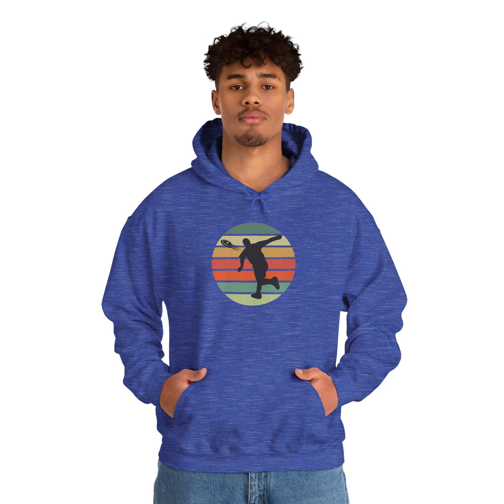 A man wearing a blue hoodie with a graphic of a silhouette disc golf player above a colorful retro image, on a white background.