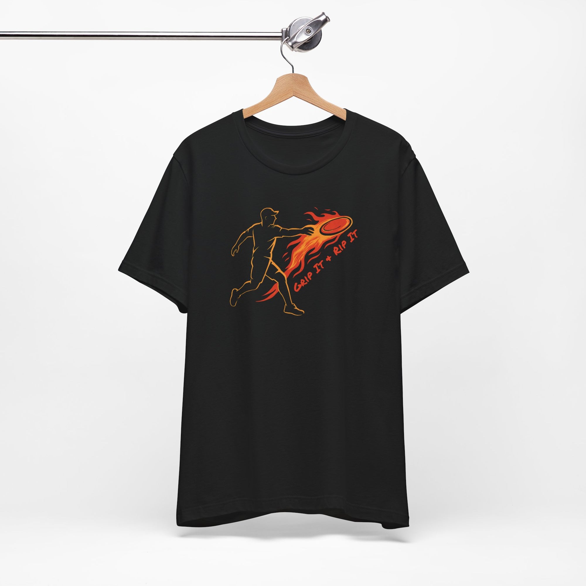 Black t-shirt with a graphic design of a person throwing a disc golf disc with flames coming off the disc and text 'Grip It or Rip It' on a hanger against a white background.