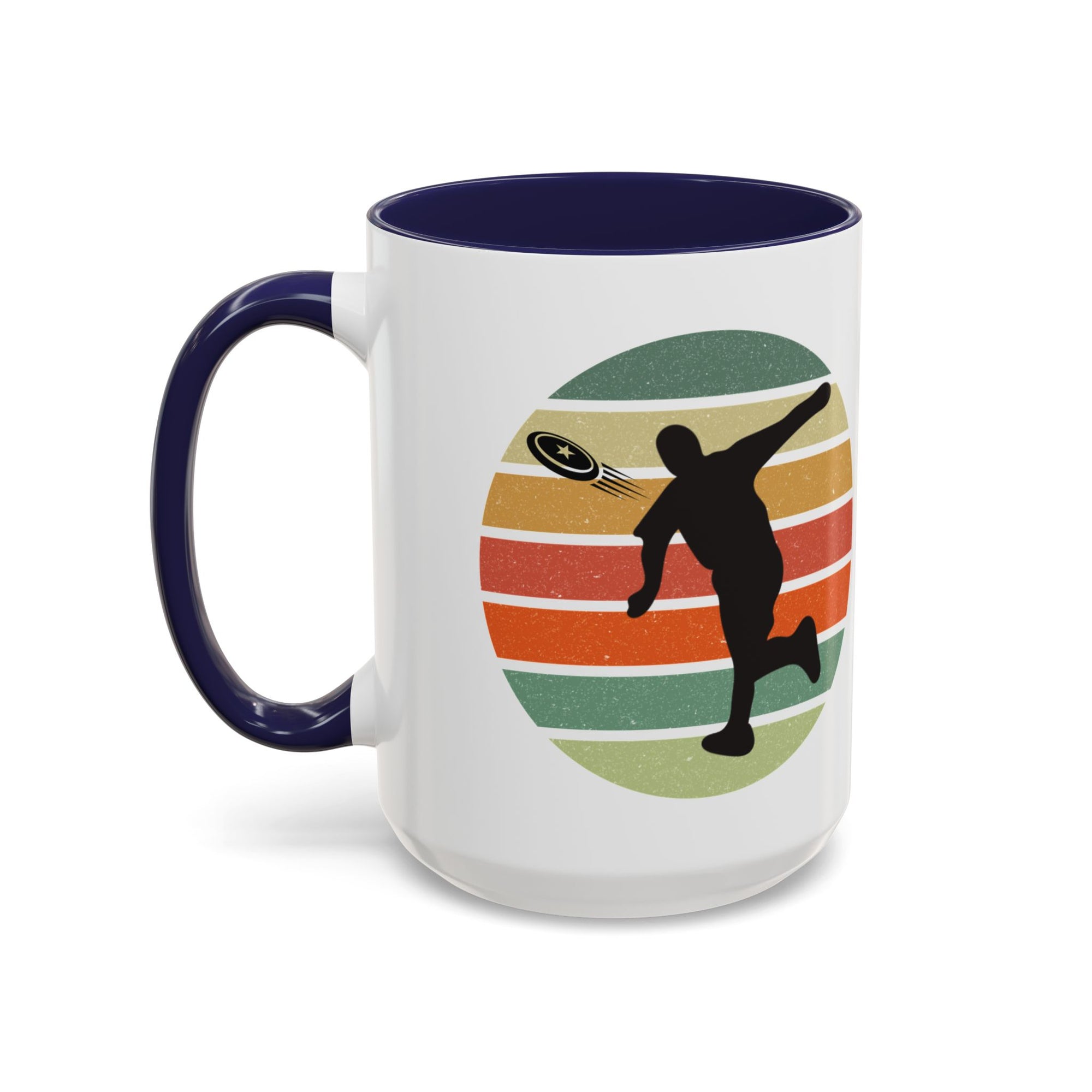 White ceramic coffee mug with dark blue accents on the handle and inside. The mug features a graphic of a silhouette of a disc golf player above a colorful retro design.