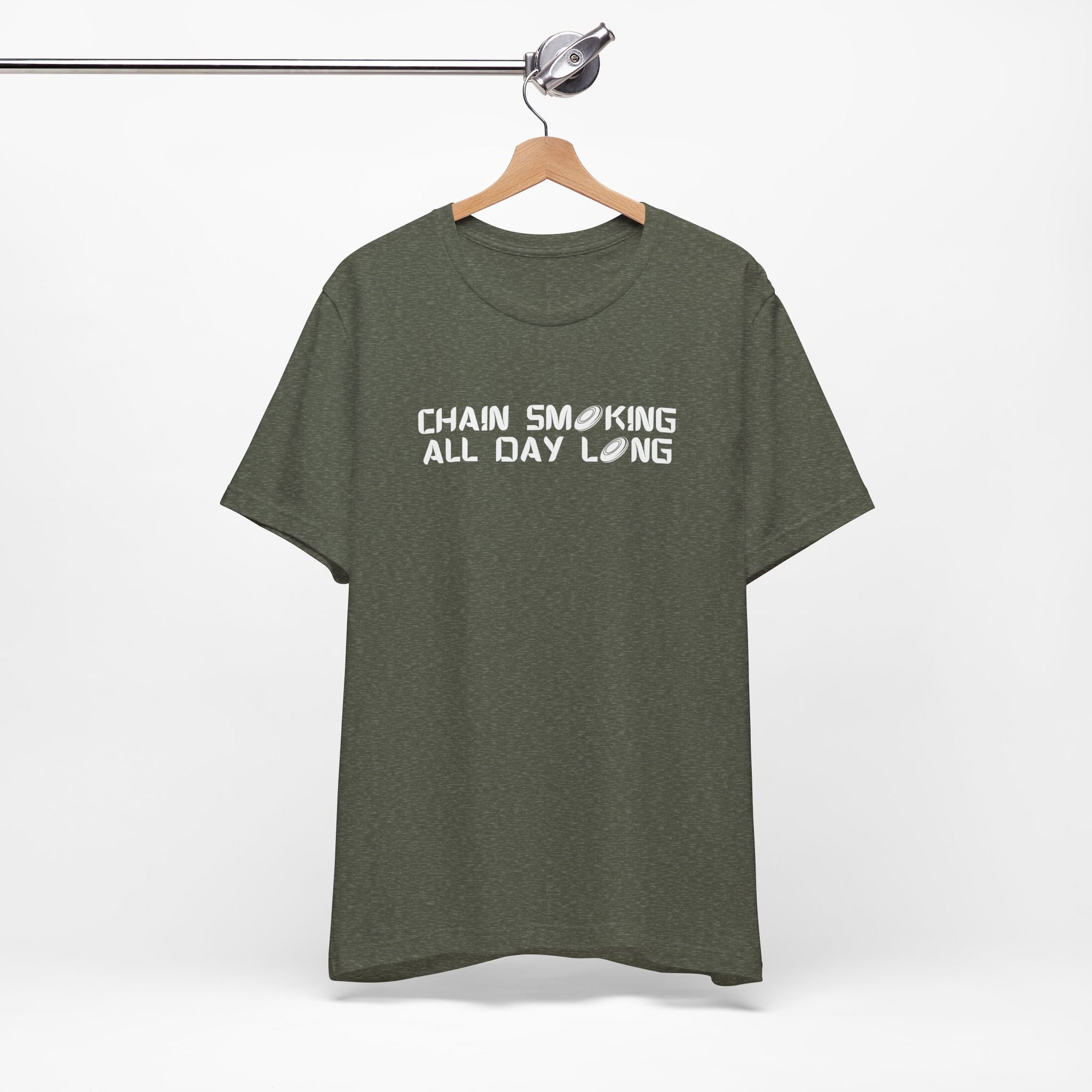 Military green t-shirt with 'CHAIN SMOKING ALL DAY LONG' text with the O's replaced by disc golf discs, on a hanger against a white background