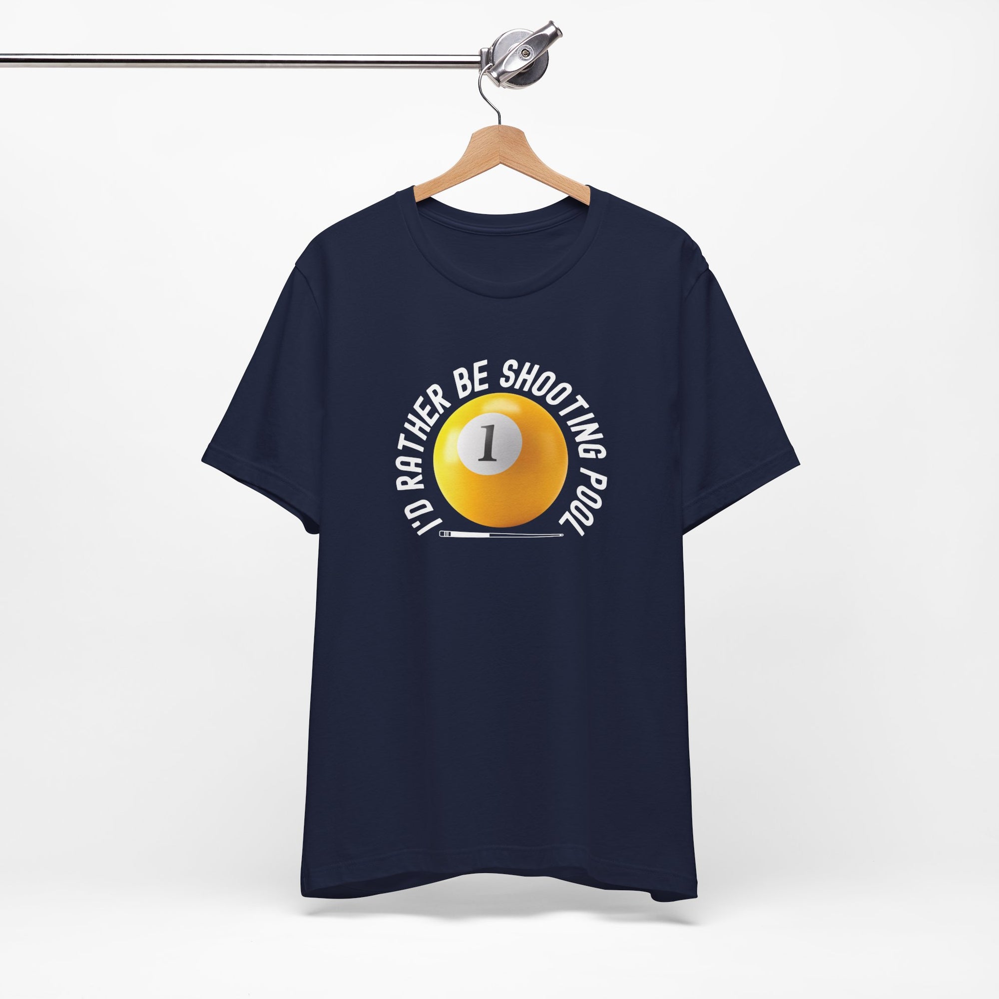 Navy blue t-shirt with a yellow billiards ball and cue stick graphic and the text "I'd Rather Be Shooting Pool" on a hanger against a white background