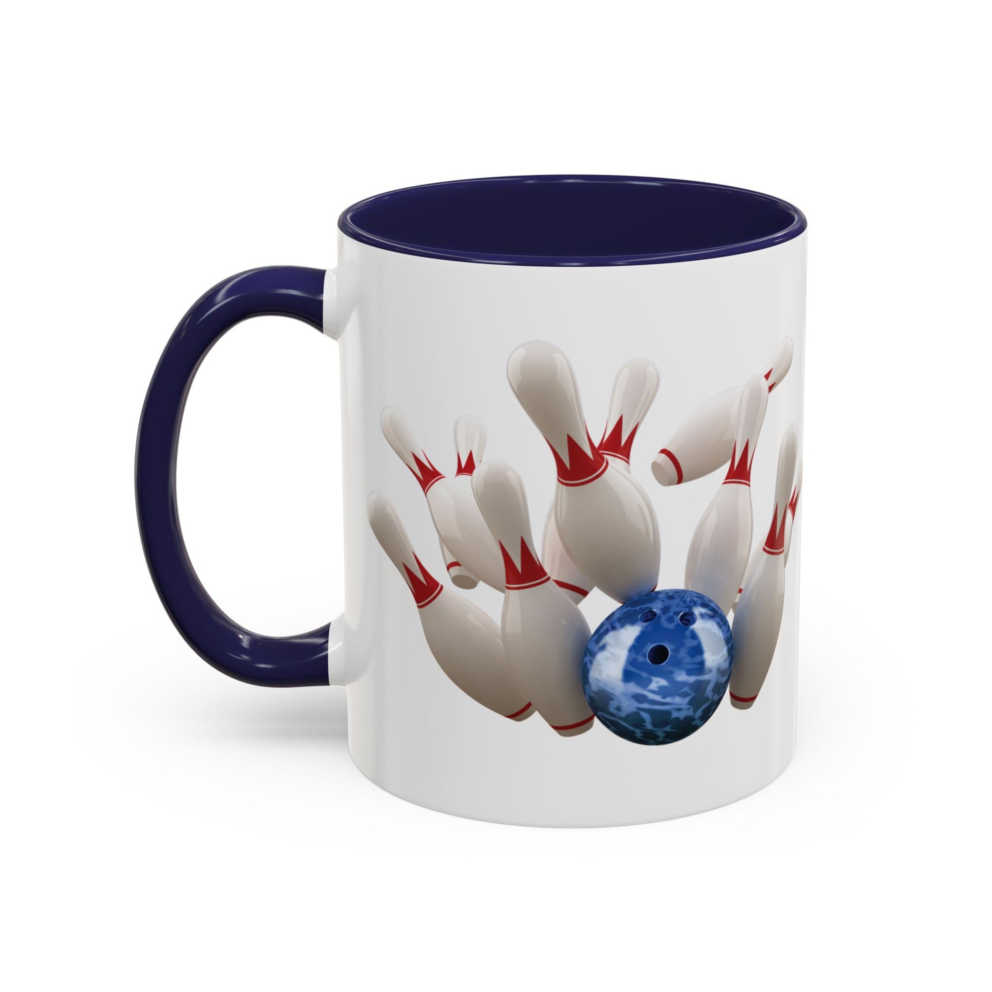 A white ceramic coffee mug with dark blue accents on the handle and interior, with a graphic of a blue bowling ball knocking over bowling pins, on a white background