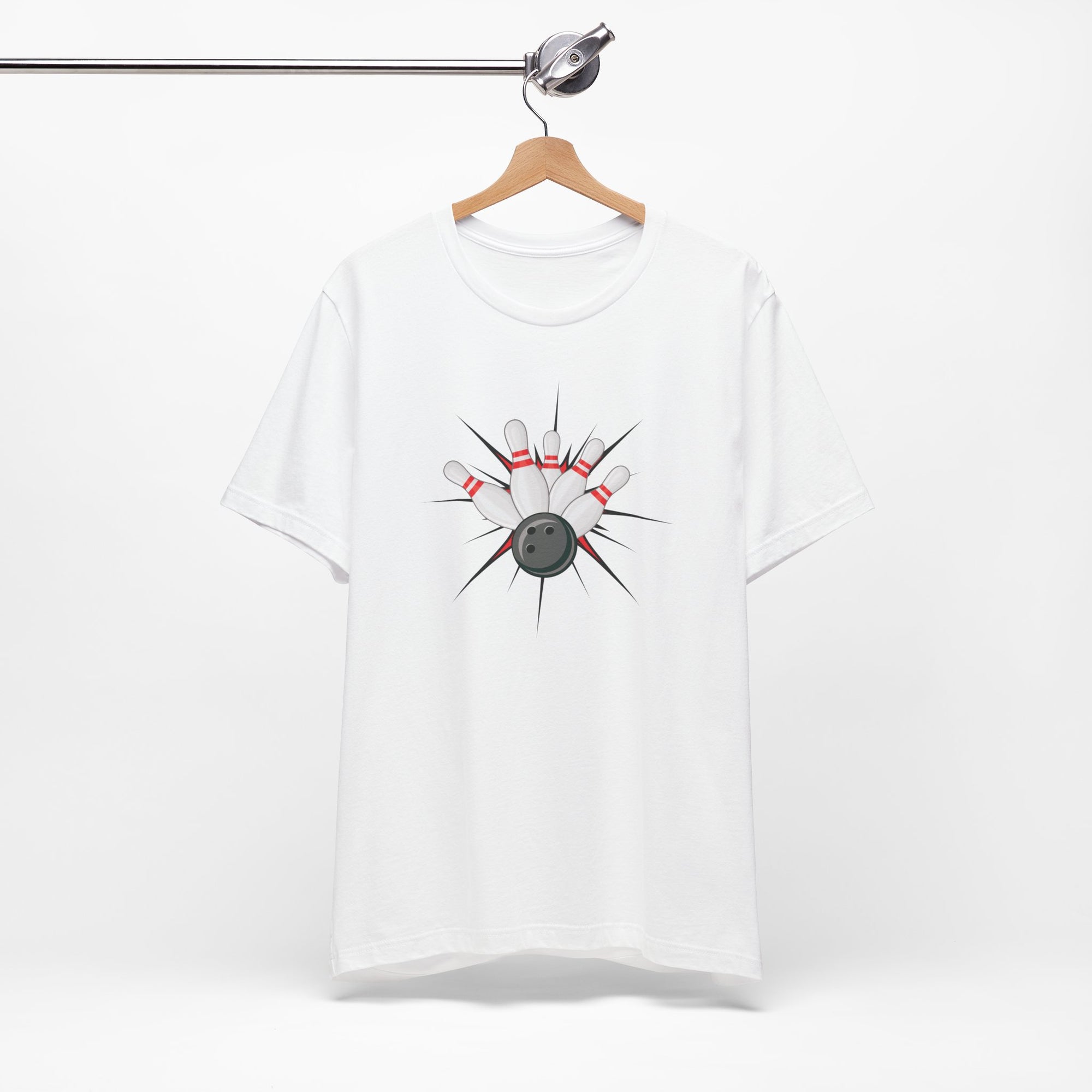 White t-shirt with a graphic design of a bowling ball smashing into pins on a hanger against a white background