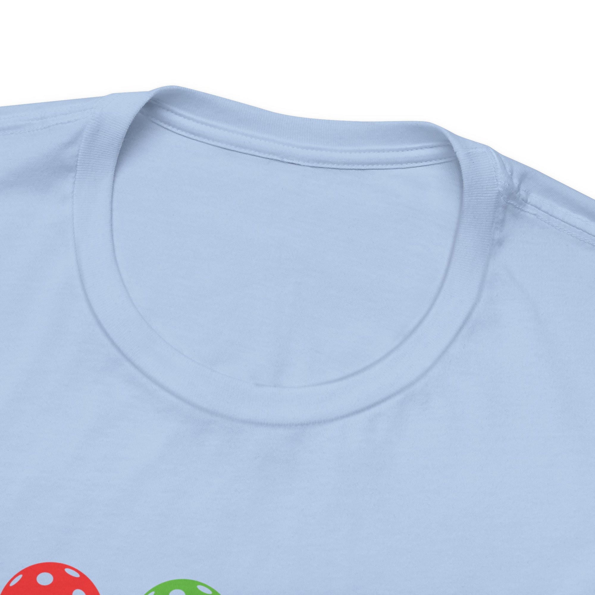 Neckline view of a light blue t-shirt with colorful flowers made from pickleballs on green stems with leaves, on a hanger against a white background