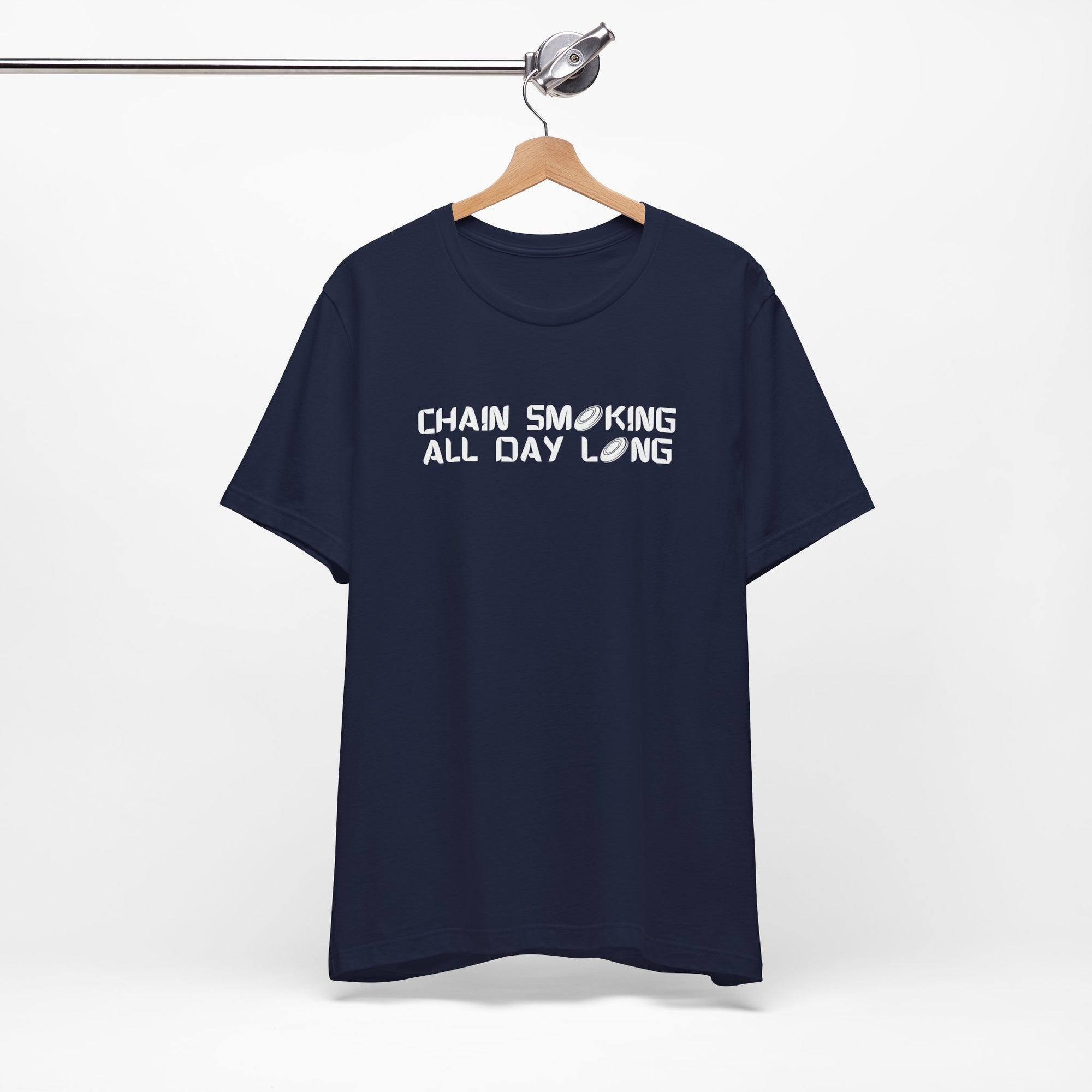 Navy blue t-shirt with 'CHAIN SMOKING ALL DAY LONG' text with the O's replaced by disc golf discs, on a hanger against a white background