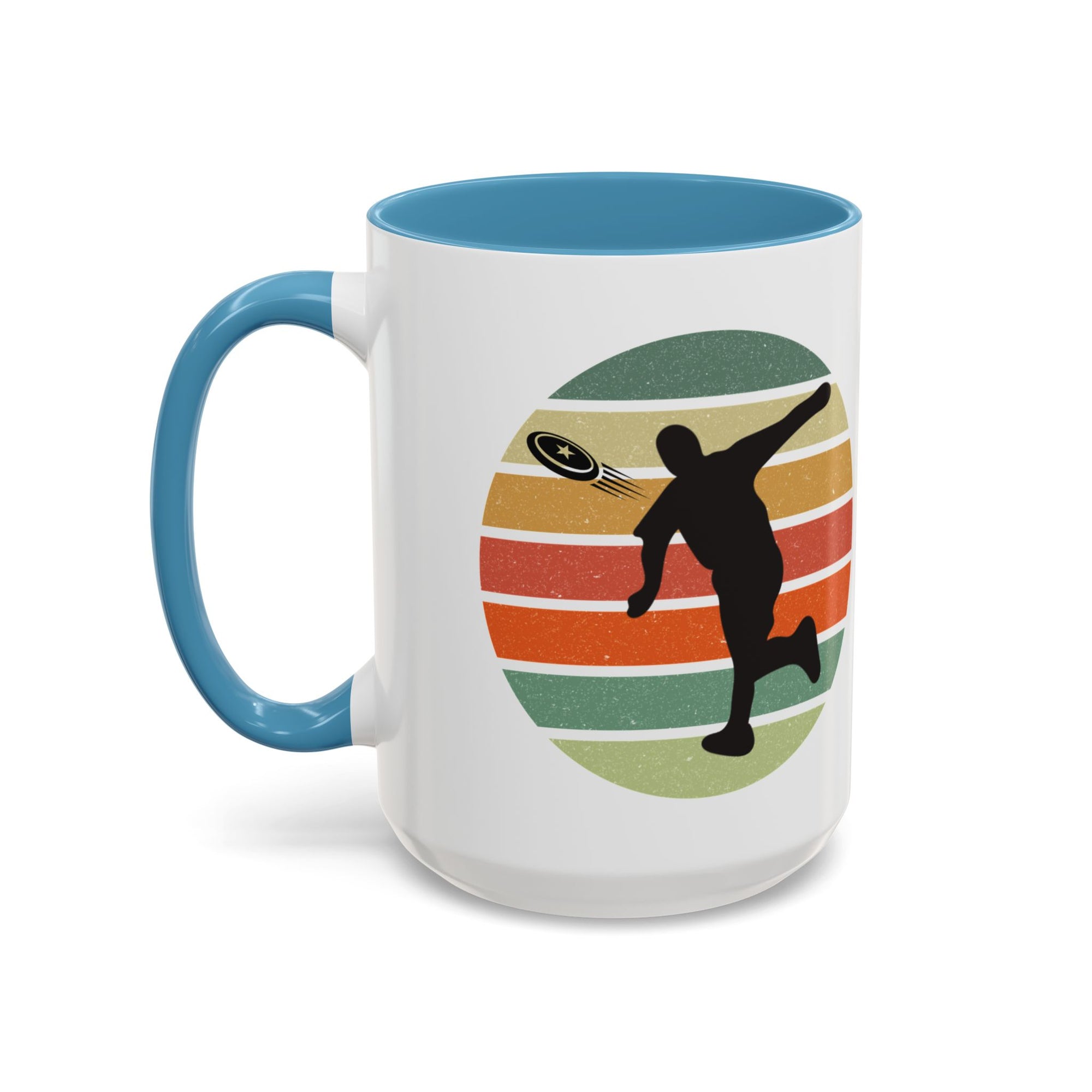 White ceramic coffee mug with light blue accents on the handle and inside. The mug features a graphic of a silhouette of a disc golf player above a colorful retro design.