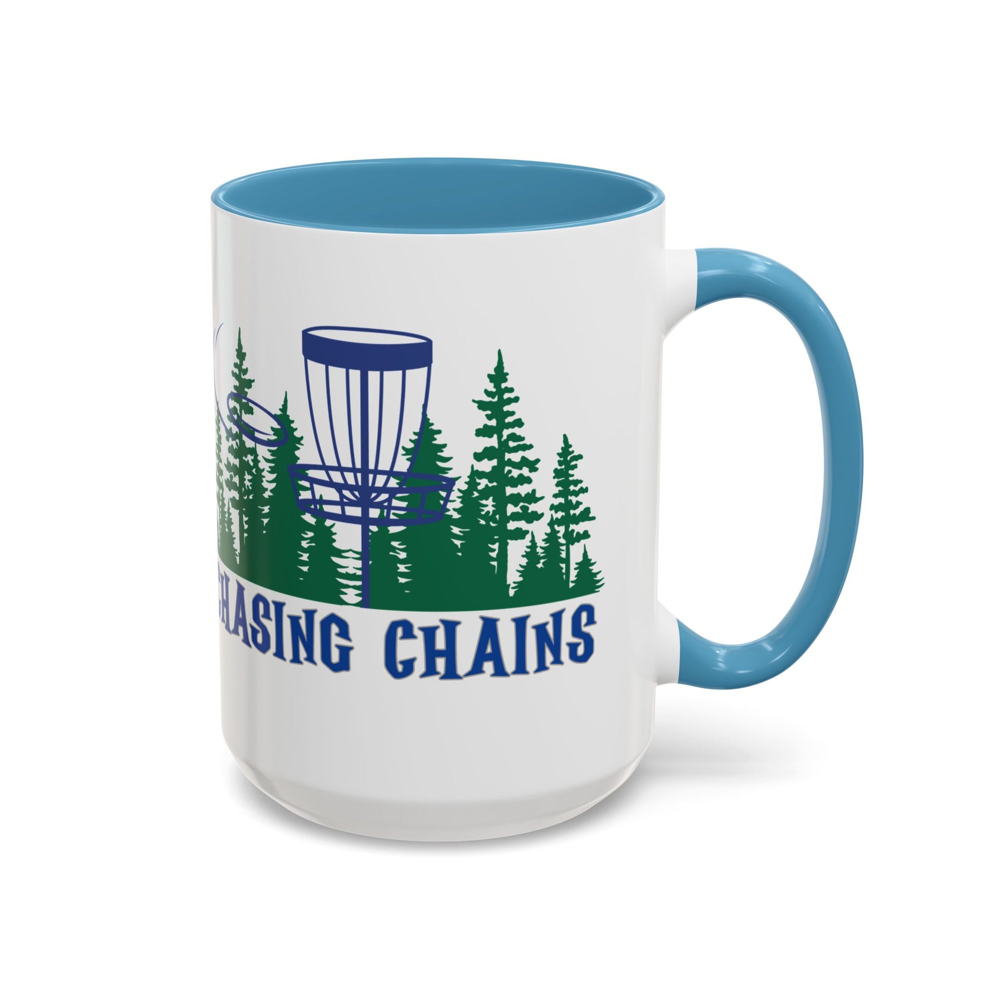 A ceramic coffee mug with light blue accents on the handle and interior, with 'Chasing Chains' graphic featuring a flying disc golf disc and basket and chains in front of a scenic evergreen tree landscape, against a white background