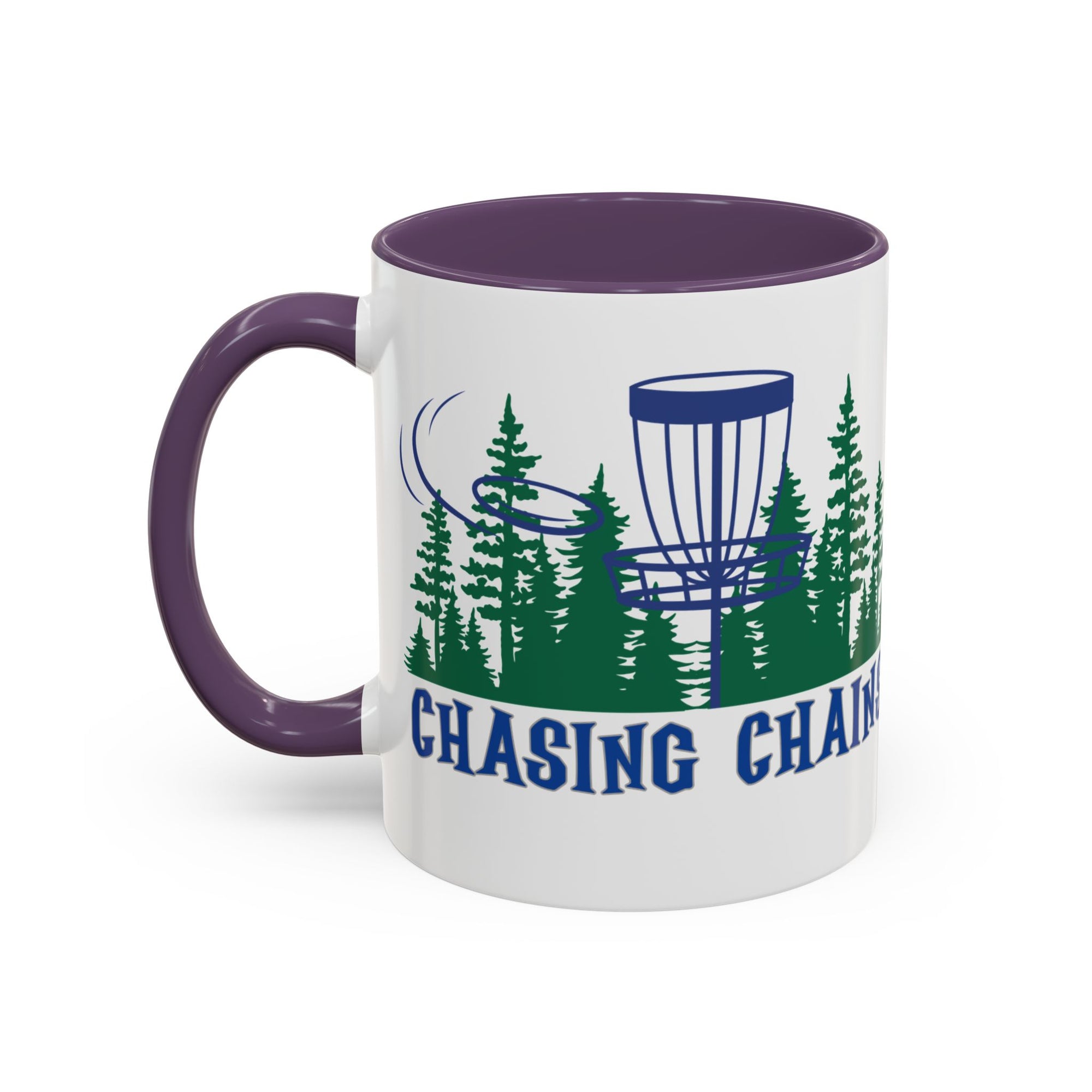 A ceramic coffee mug with purple accents on the handle and interior, with 'Chasing Chains' graphic featuring a flying disc golf disc and basket and chains in front of a scenic evergreen tree landscape, against a white background