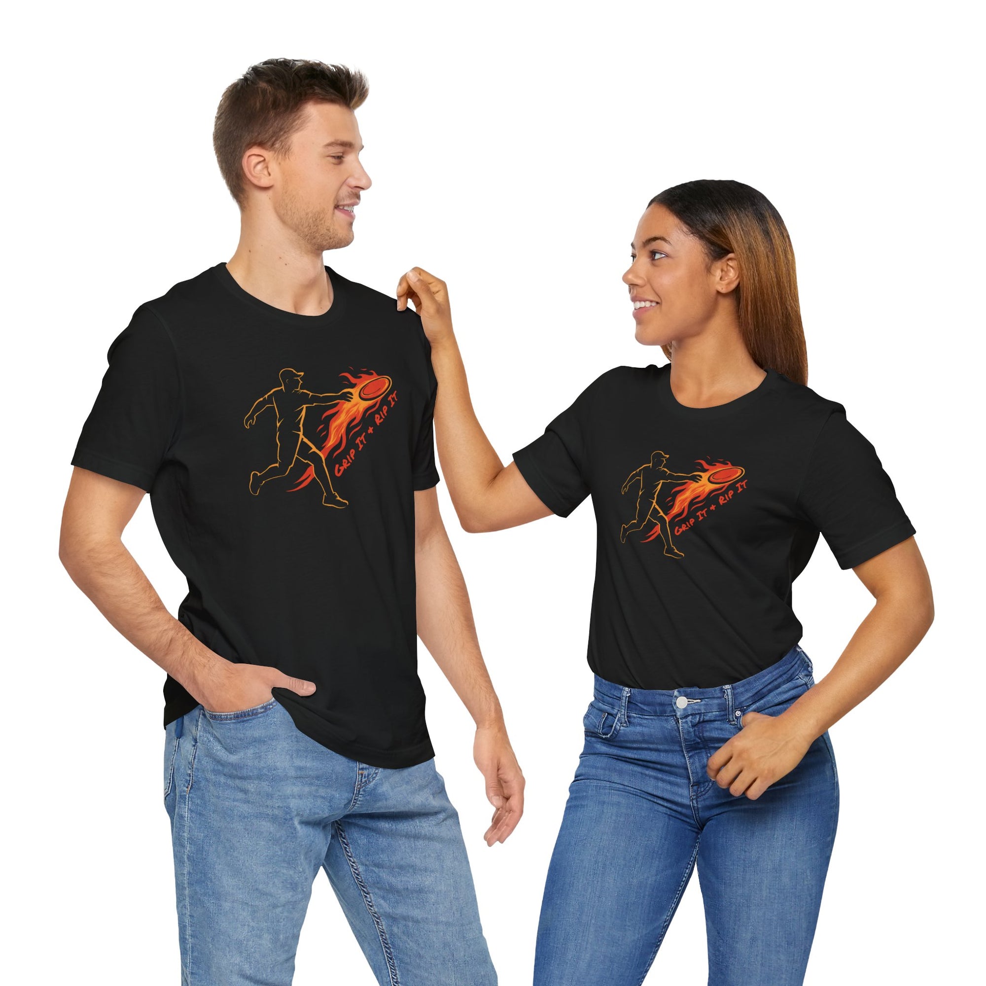 A man and a woman wearing a black t-shirt with a graphic design of a person throwing a disc golf disc with flames coming off the disc and text 'Grip It or Rip It' on a hanger against a white background.