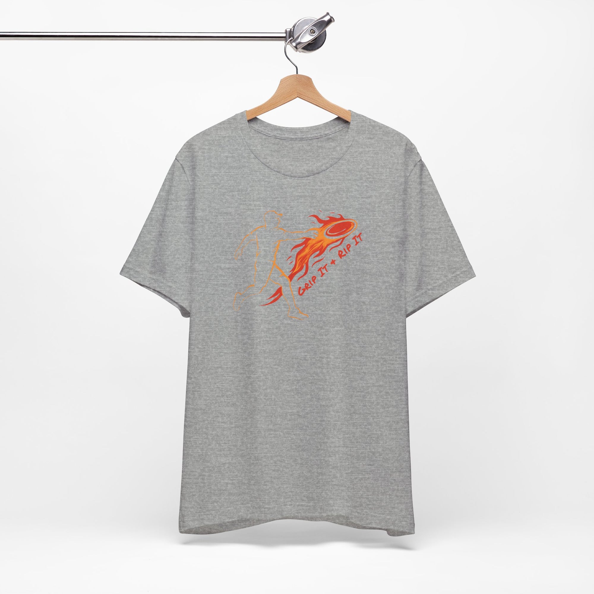 Light gray t-shirt with a graphic design of a person throwing a disc golf disc with flames coming off the disc and text 'Grip It or Rip It' on a hanger against a white background.