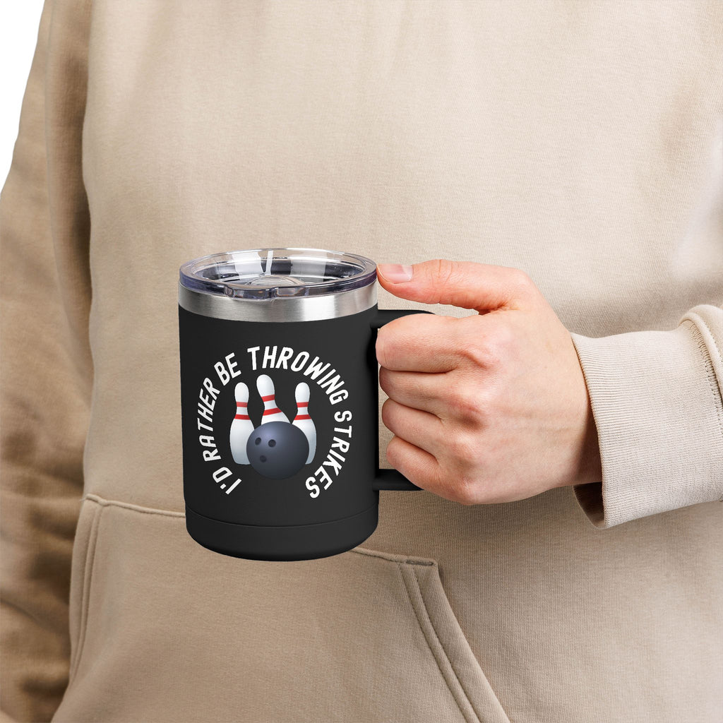 Man holding a black travel mug with a sip lid and handle, with bowling pins and a bowling ball and text saying "I'd Rather Be Throwing Strikes" on white background