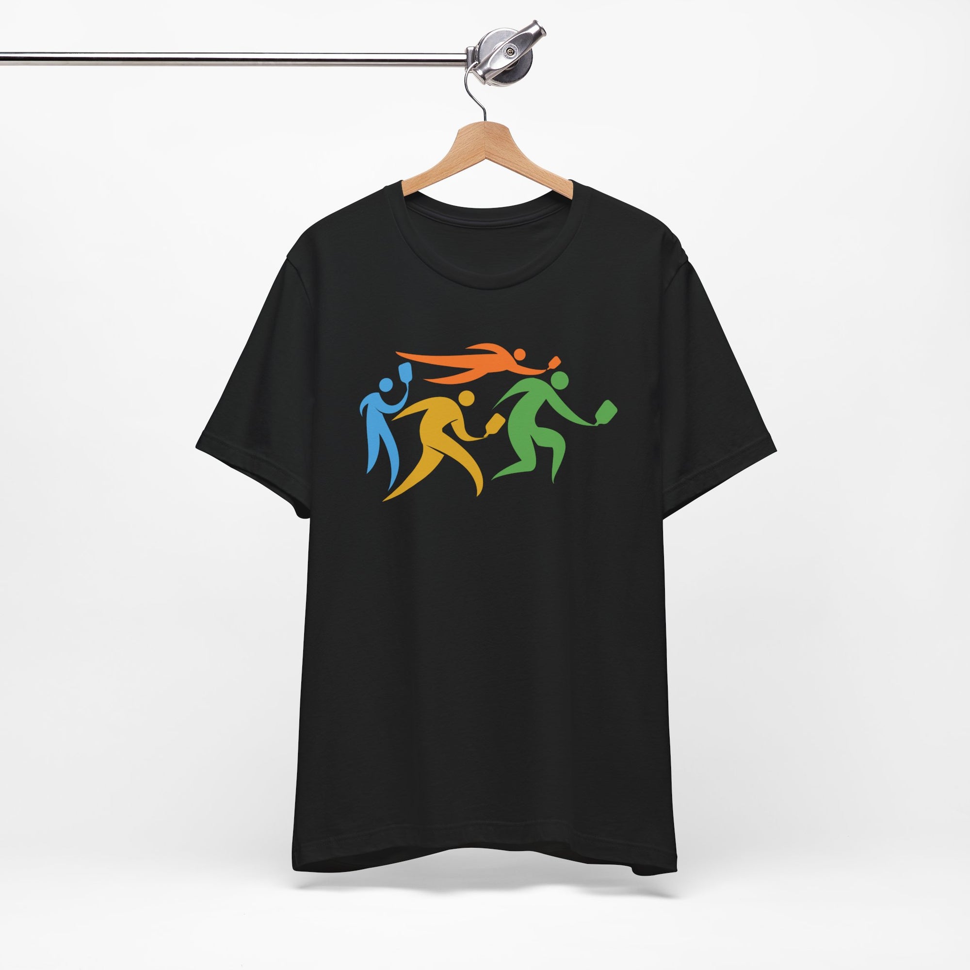 Black t-shirt featuring an image of four colorful pickleball player drawings playing pickleball, on a hanger against a white background