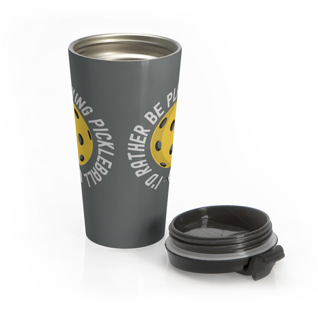 Gray travel mug with a yellow pickleball graphic and the text "I'd Rather Be Playing Pickleball" with the lid sitting next to the mug on a white background