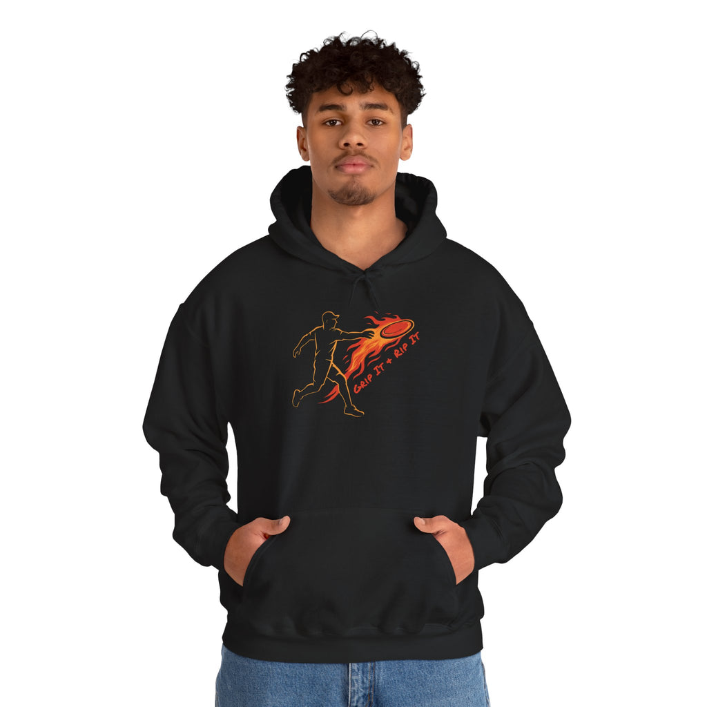A man wearing a black hoodie with a graphic design of a person throwing a disc golf disc with flames coming off the disc and text 'Grip It or Rip It' against a white background.