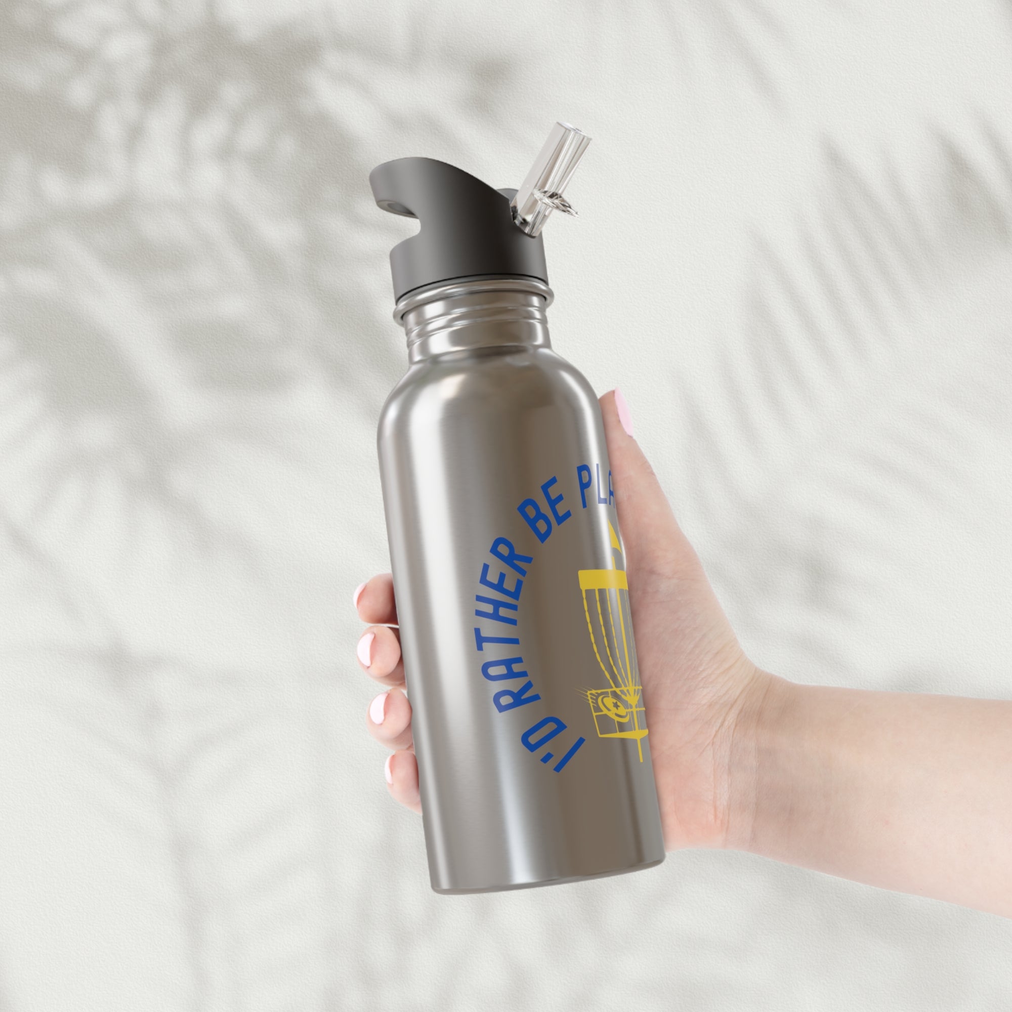 Person holding a stainless steel water bottle with cap, with a graphic of disc golf chains, basket, and disc and text that says "I'd Rather Be Playing Disc Golf" on a white background