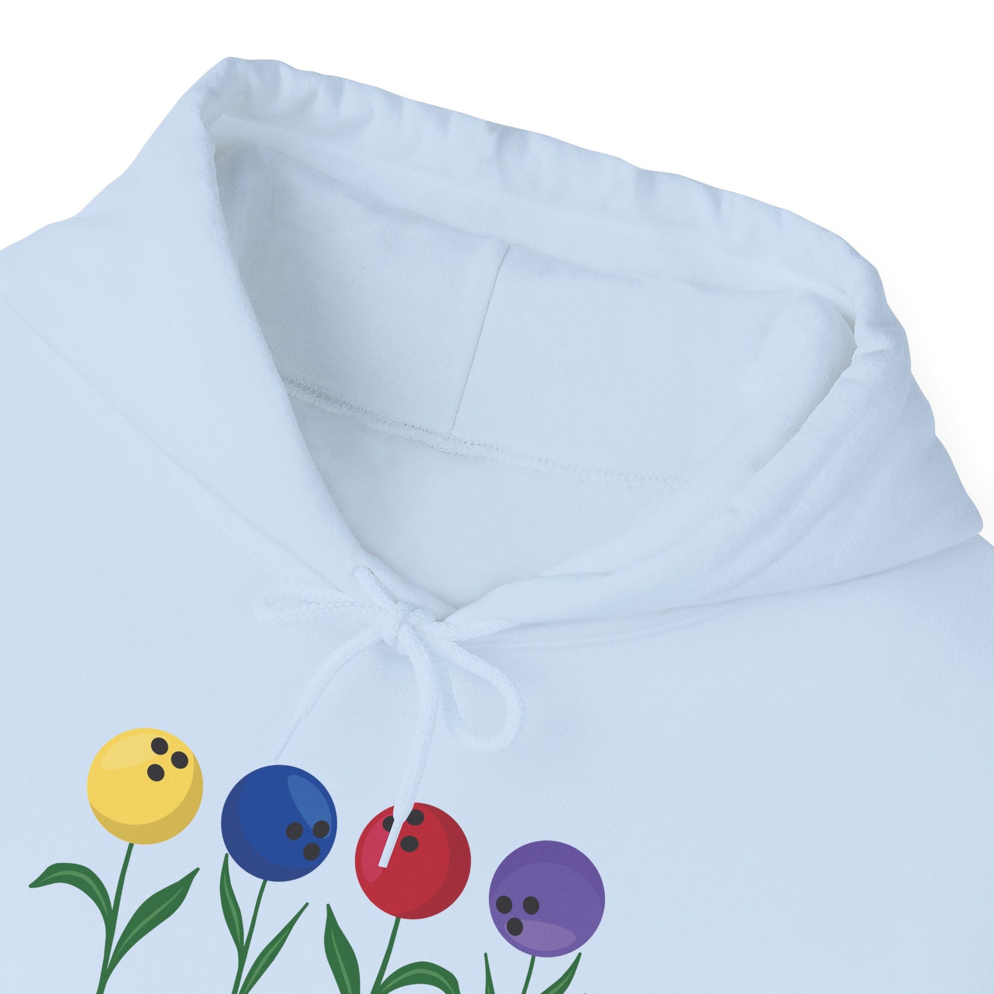 Close-up of the neckline of a light blue hoodie with colorful flowers made out of bowling balls, on a white background