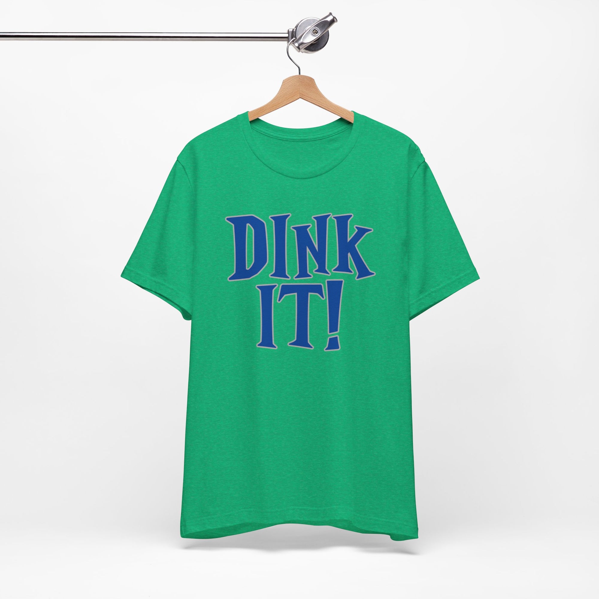 Green t-shirt with 'DINK IT!' text in blue and outlined in gray, on a hanger against a white background
