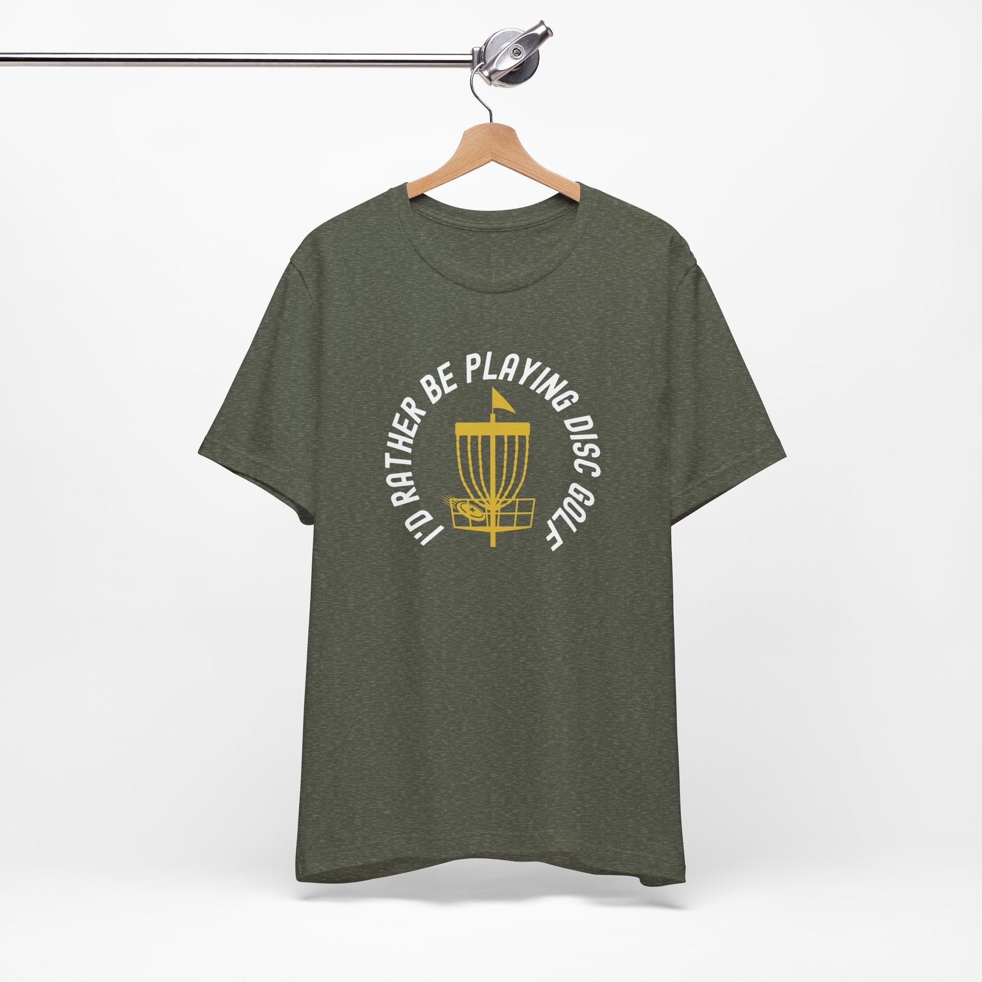 Olive color t-shirt with a graphic of disc golf chains, basket, and disc and text that says "I'd Rather Be Playing Disc Golf" on a hanger against a white background