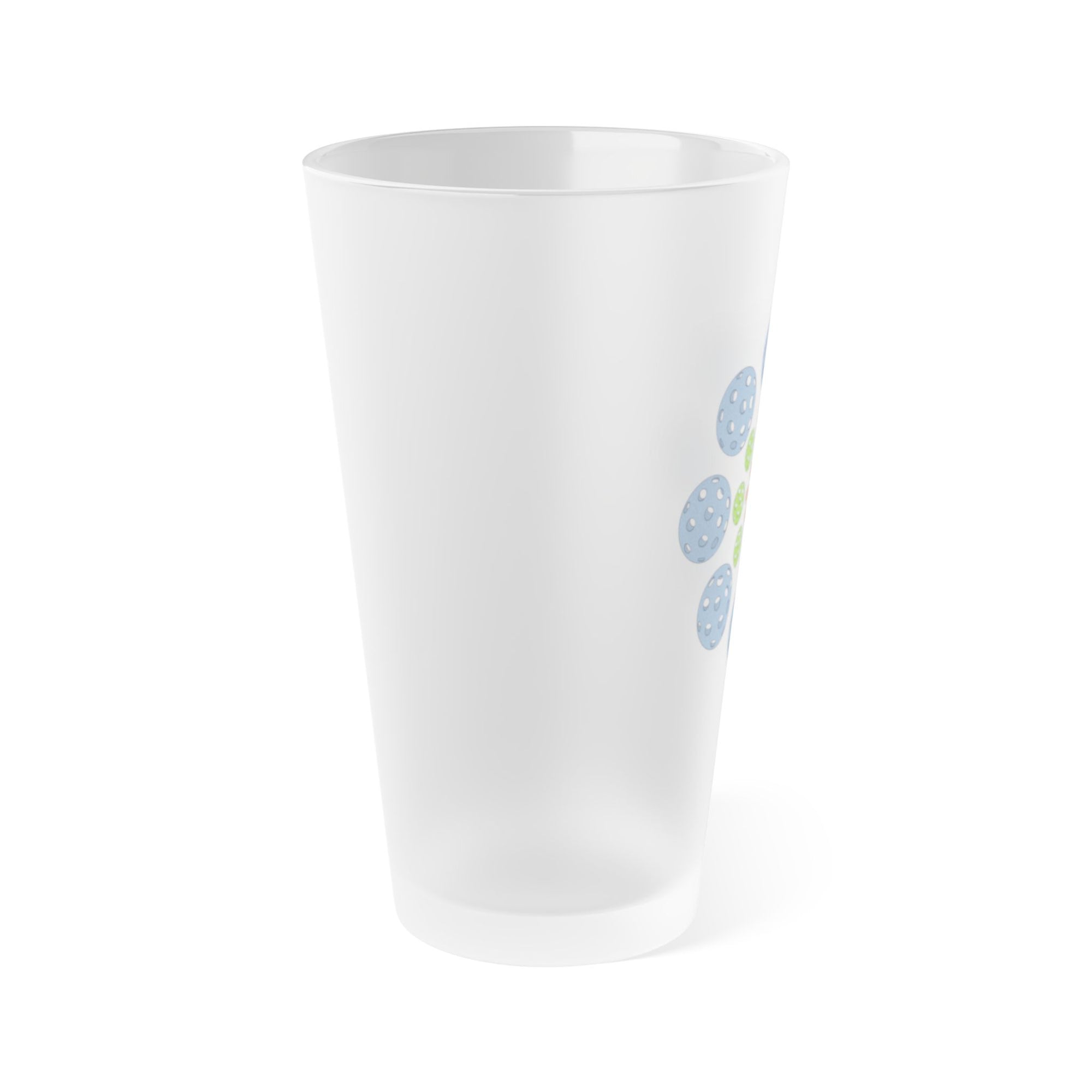Side view of a frosted pint glass with colorful pickleballs in a circular pattern, on a white background