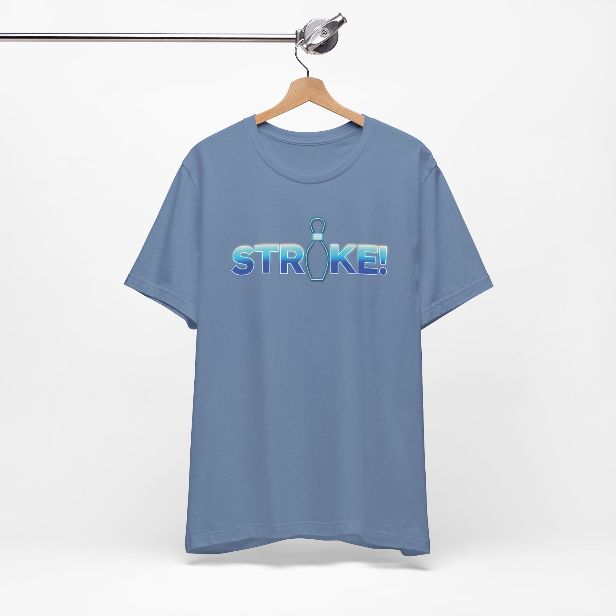 Steel blue bowling t-shirt with 'STRIKE!' with the "I" replaced by a bowling pin, on a hanger against a white background