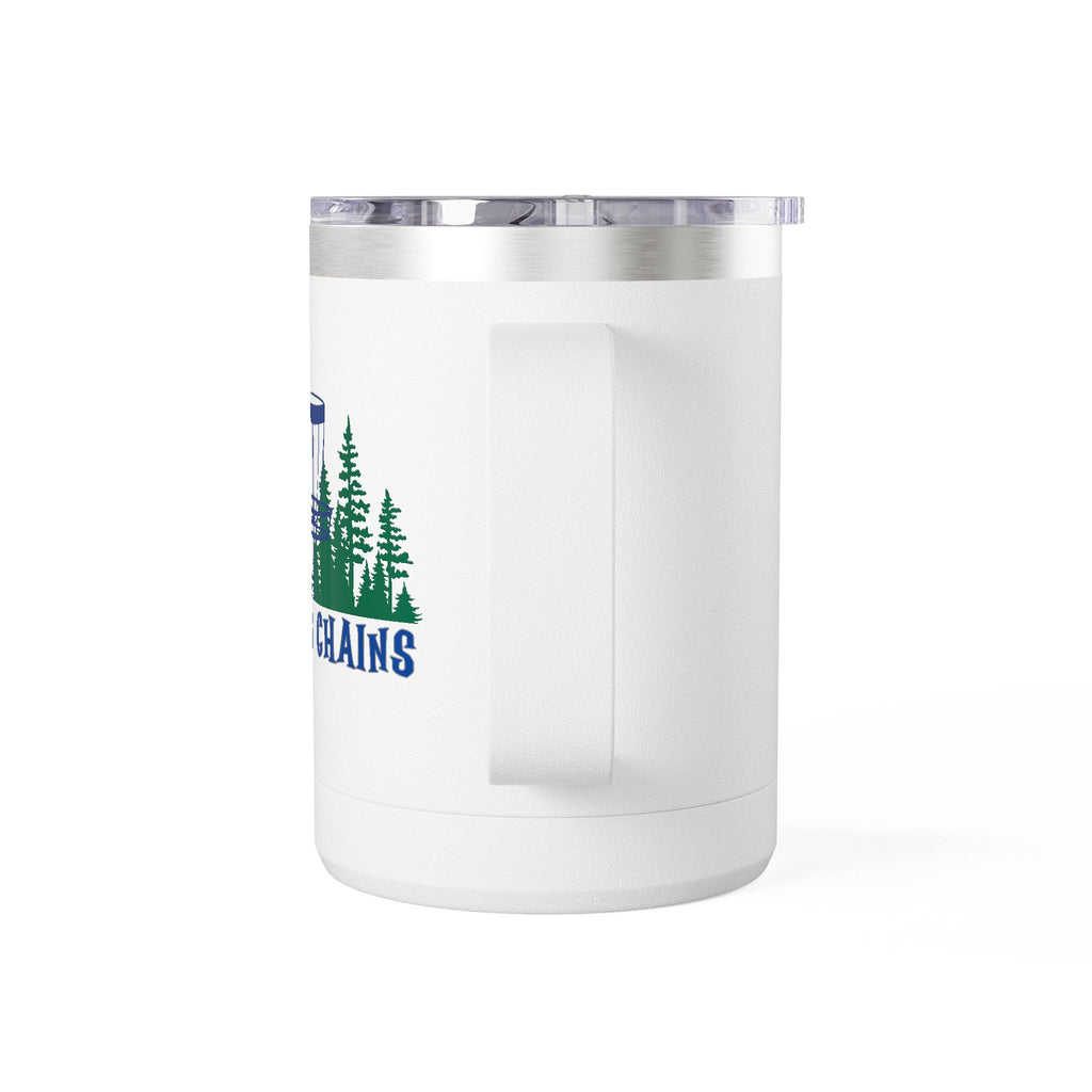 Back view of the handle of a white travel coffee tumbler mug with handle and lid with 'Chasing Chains' graphic featuring a flying disc golf disc and basket and chains in front of a scenic evergreen tree landscape, against a white background