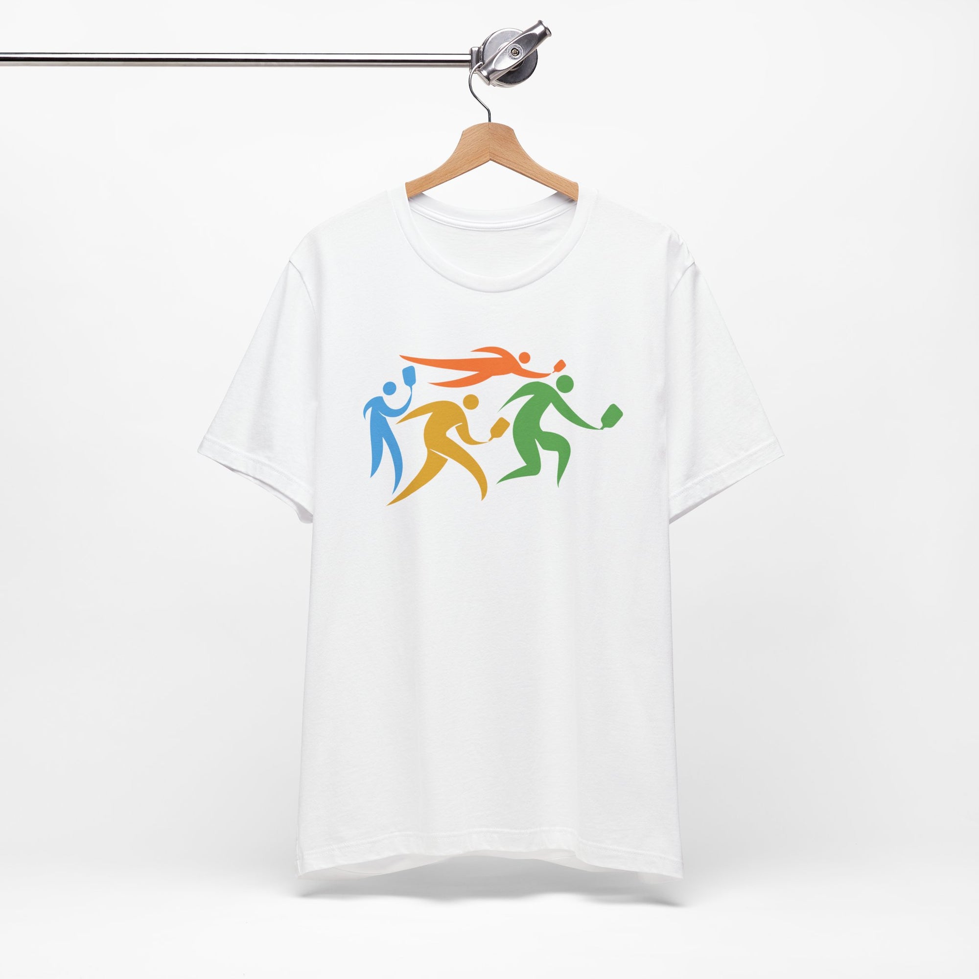White t-shirt featuring an image of four colorful pickleball player drawings playing pickleball, on a hanger against a white background
