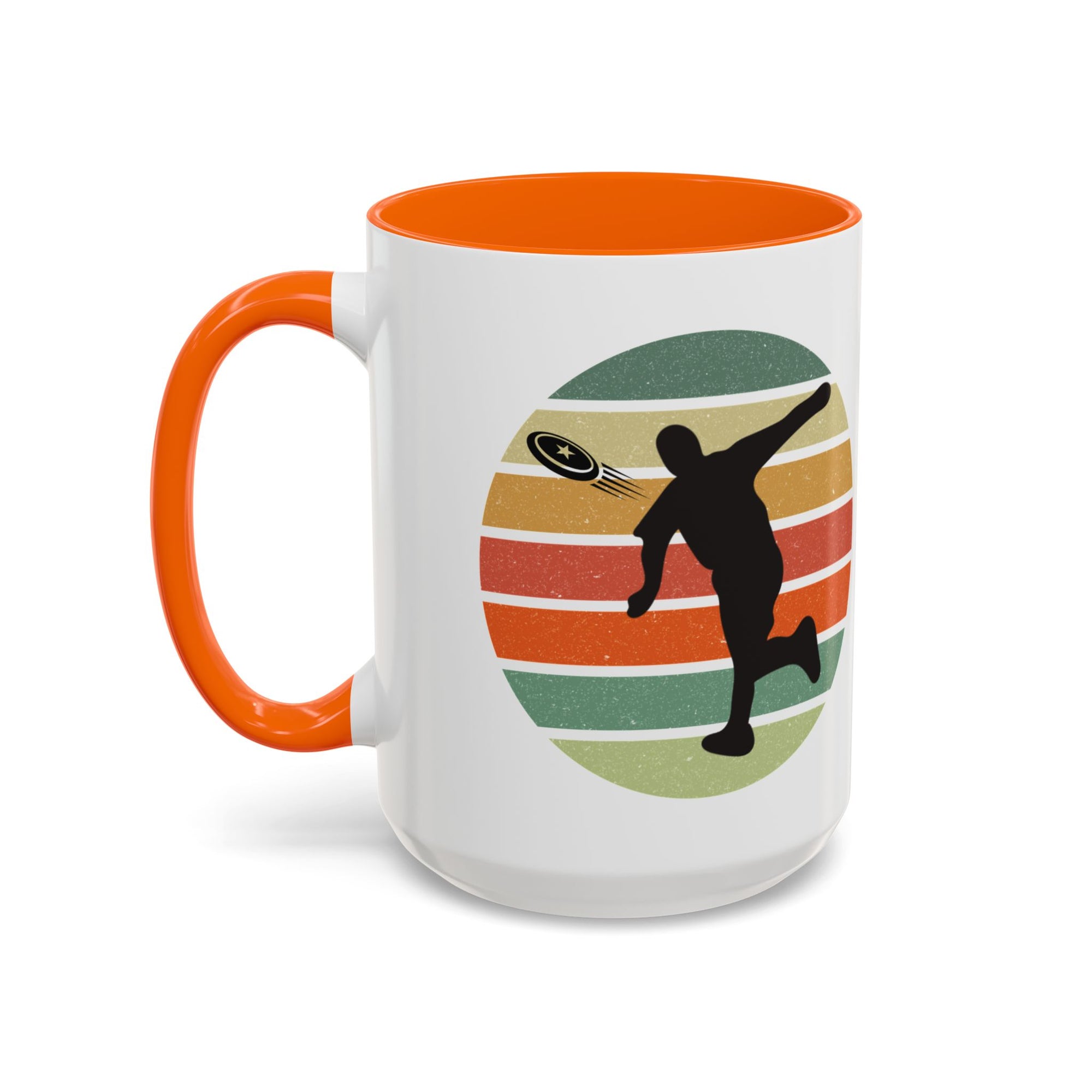 White ceramic coffee mug with orange accents on the handle and inside. The mug features a graphic of a silhouette of a disc golf player above a colorful retro design.