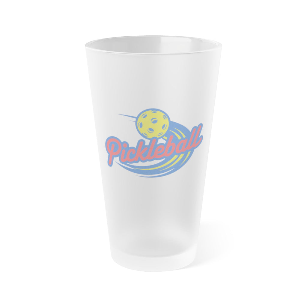 A frosted pint glass with an image of a pickleball logo and a yellow pickleball, on a white background.