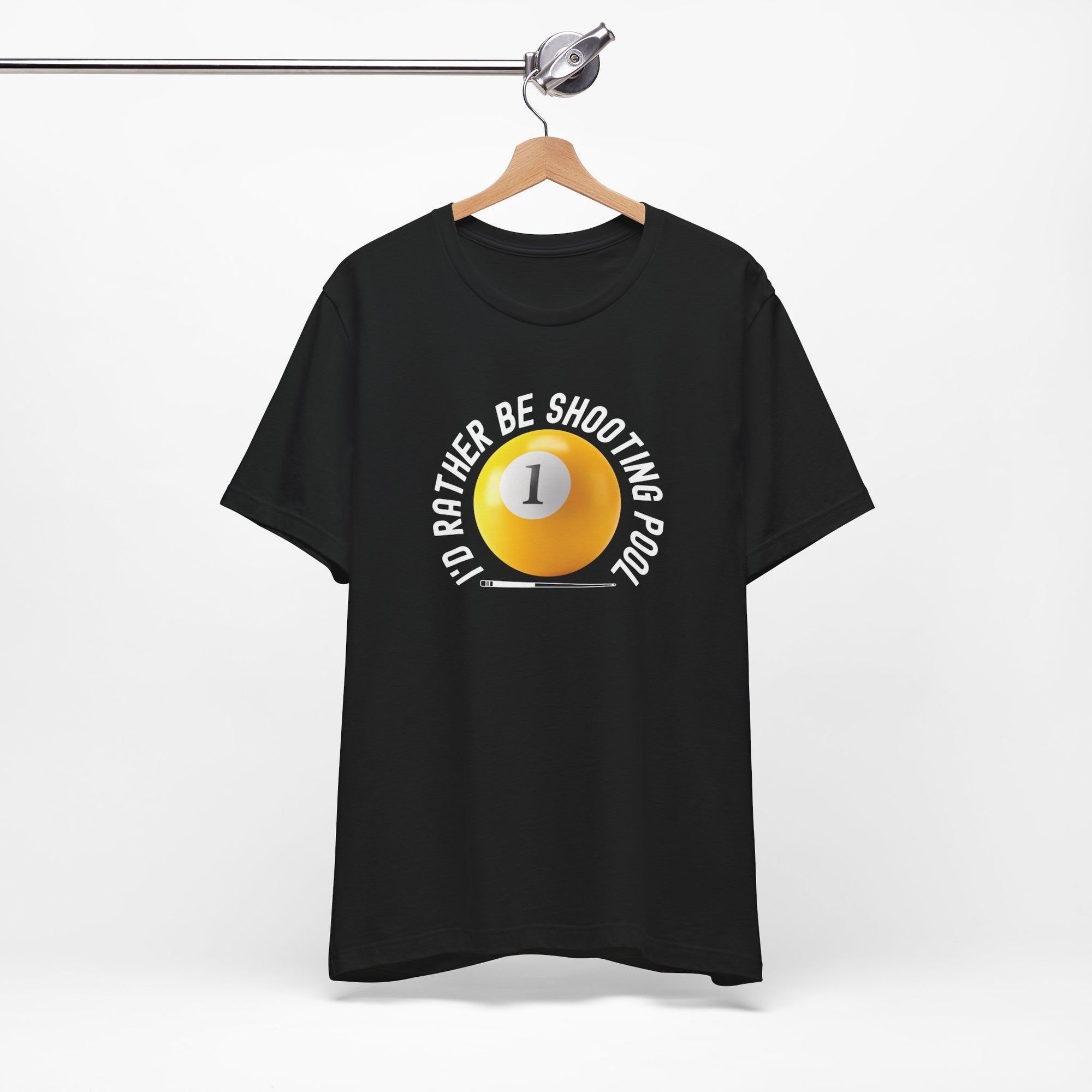 Black t-shirt with a yellow billiards ball and cue stick graphic and the text "I'd Rather Be Shooting Pool" on a hanger against a white background