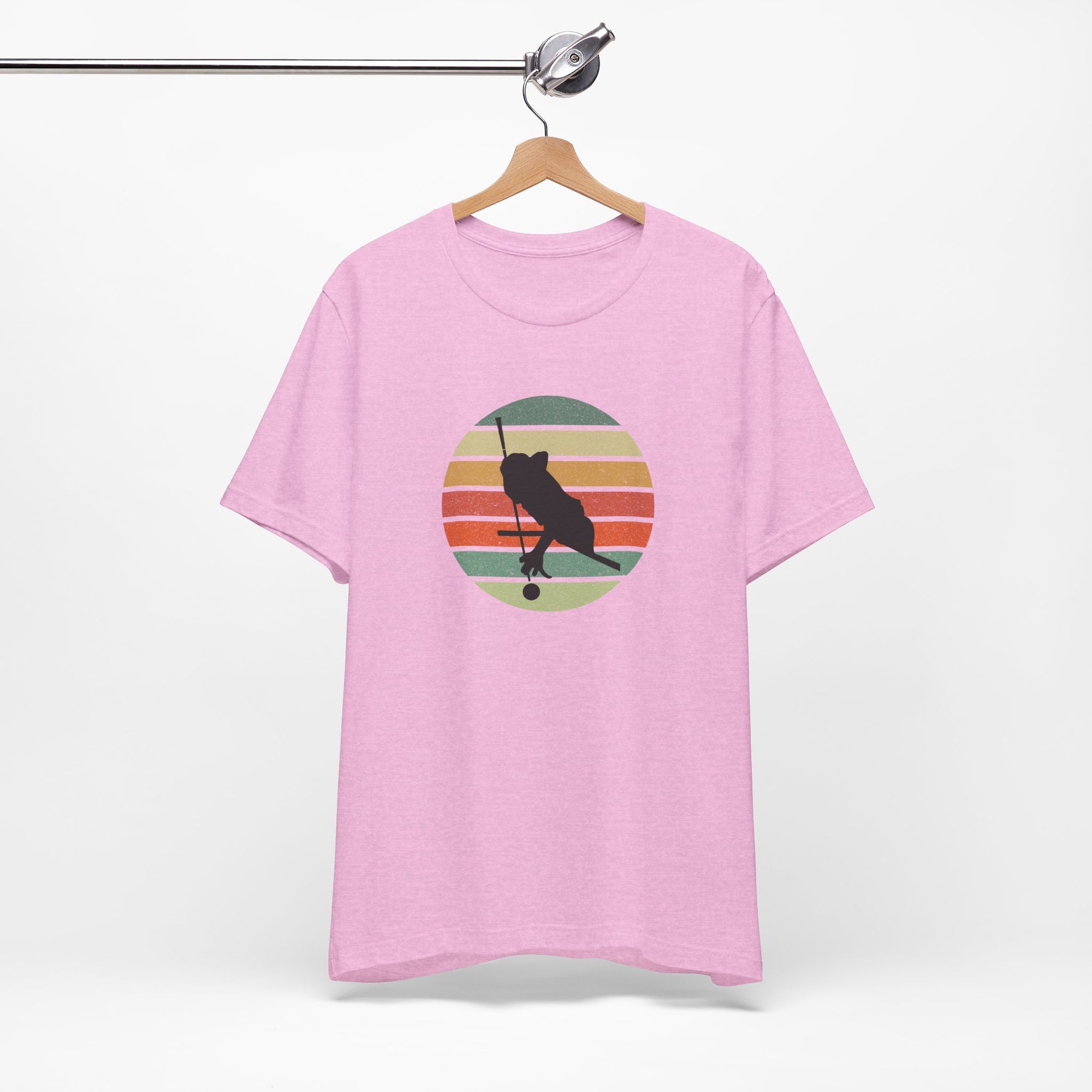 Pink t-shirt with a graphic of a billiards player silhouette over a colorful retro image against a white background