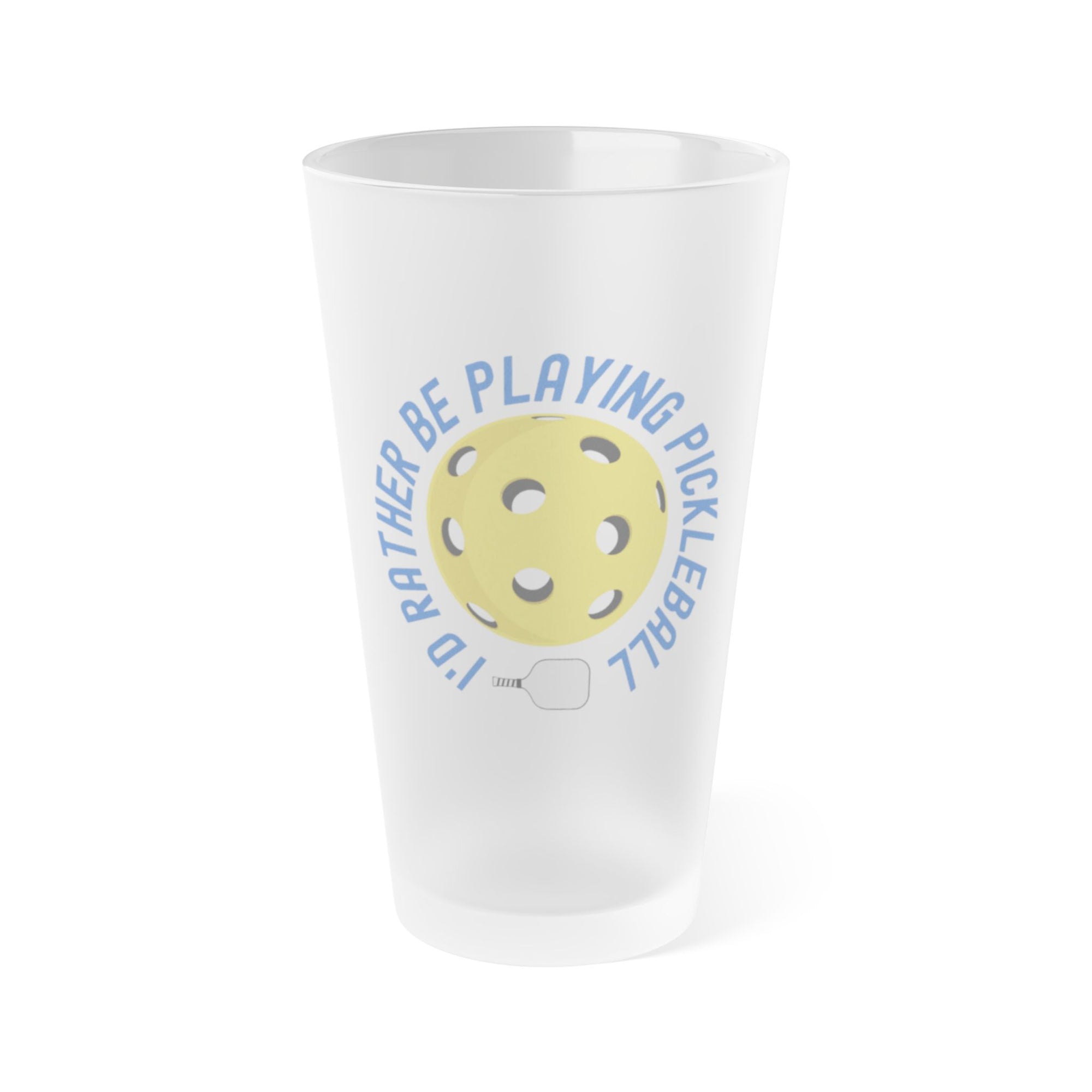 A frosted pint glass with the words "I'd Rather Be Playing Pickleball" surrounding a yellow pickleball and paddle, on a white background
