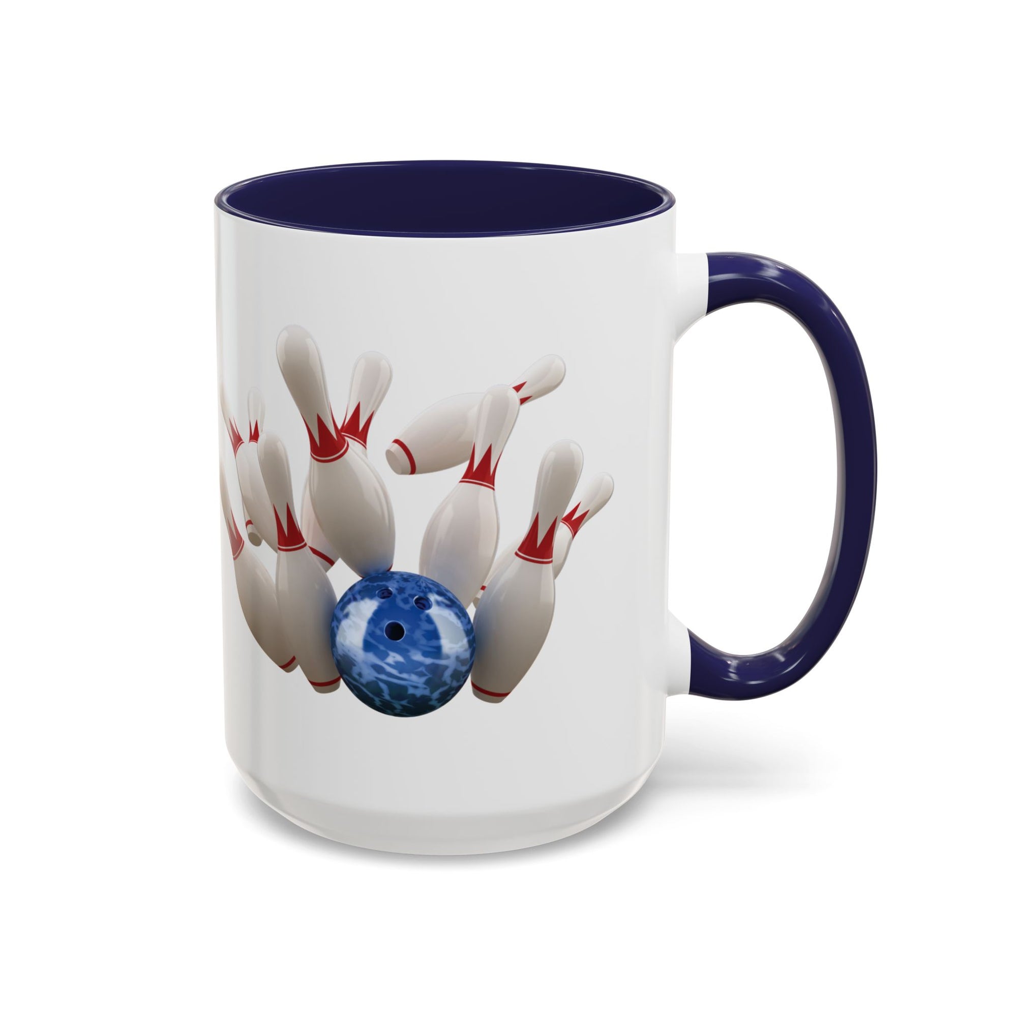 A white ceramic coffee mug with dark blue accents on the handle and interior, with a graphic of a blue bowling ball knocking over bowling pins, on a white background
