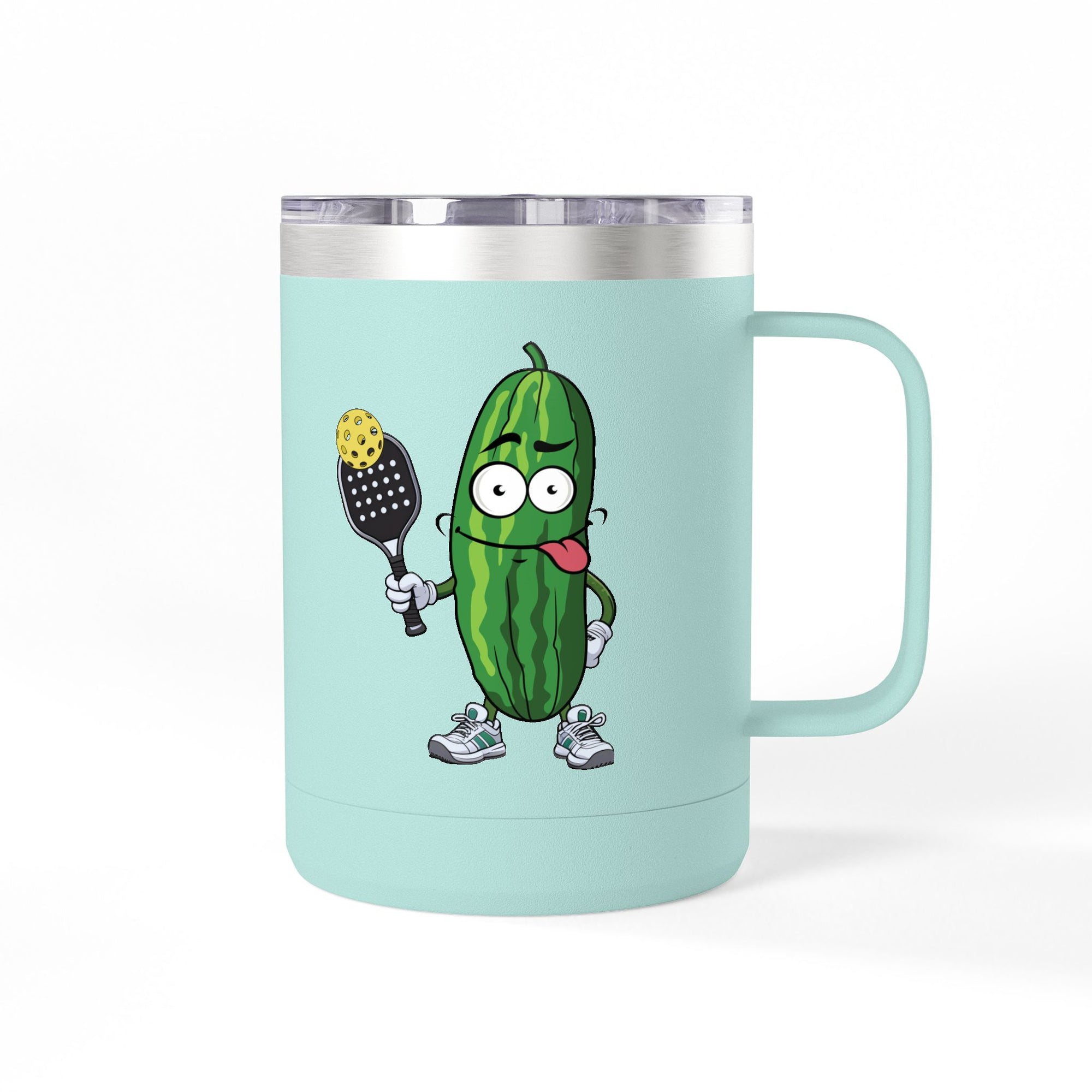 A teal travel coffee mug tumbler with handle and lid with a cartoon pickle with googly eyes and his tongue sticking out, holding a pickleball paddle with a yellow pickleball, against a white background