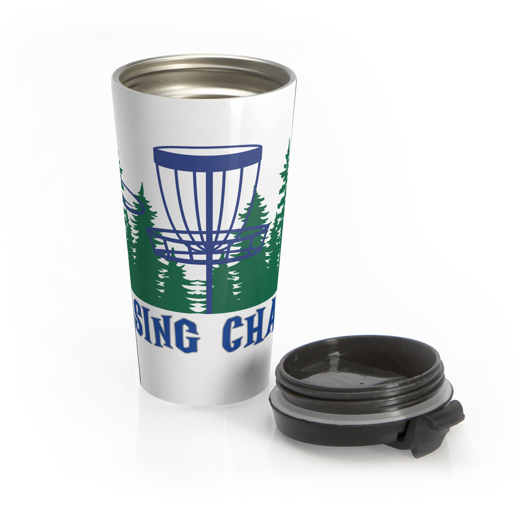 A travel tumbler mug with lid next to the mug, with 'Chasing Chains' graphic featuring a flying disc golf disc and basket and chains in front of a scenic evergreen tree landscape, against a white background