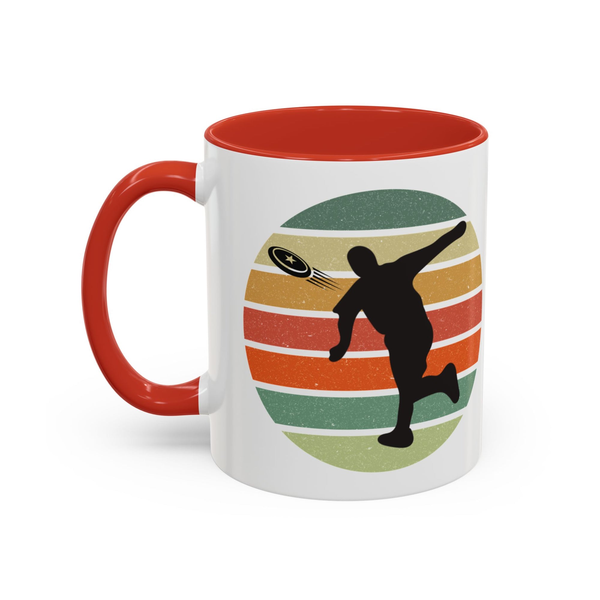 White ceramic coffee mug with red accents on the handle and inside. The mug features a graphic of a silhouette of a disc golf player above a colorful retro design.