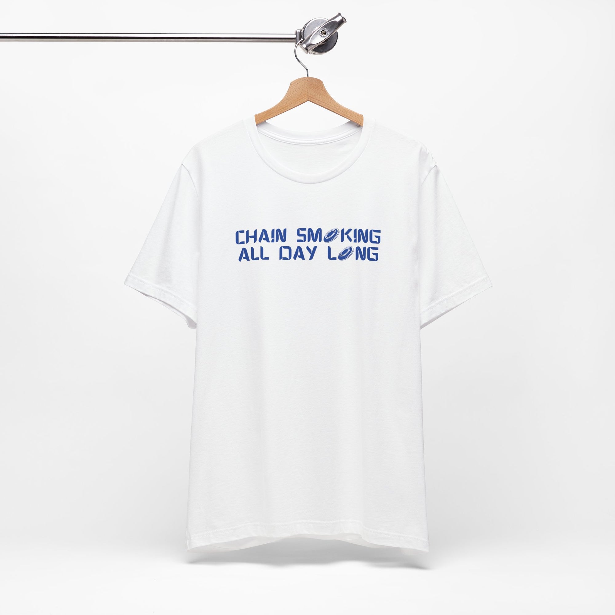 White t-shirt with 'CHAIN SMOKING ALL DAY LONG' text with the O's replaced by disc golf discs, on a hanger against a white background