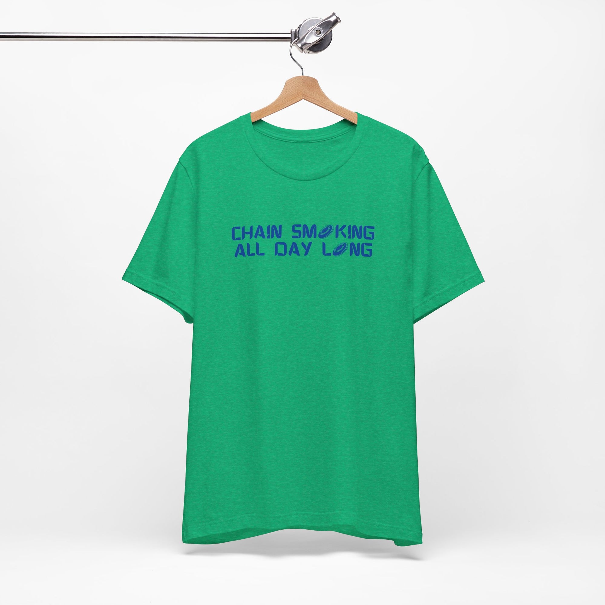 Green t-shirt with 'CHAIN SMOKING ALL DAY LONG' text with the O's replaced by disc golf discs, on a hanger against a white background