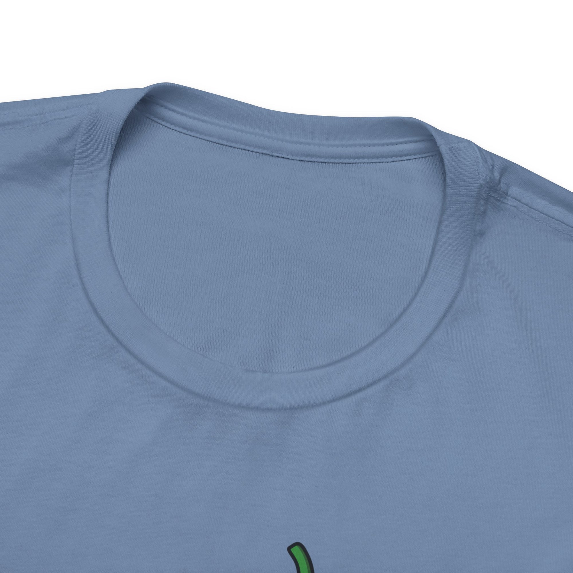 The neckline view of a steel blue t-shirt with a cartoon pickle with googly eyes and his tongue sticking out, holding a pickleball paddle with a yellow pickleball, against a white background
