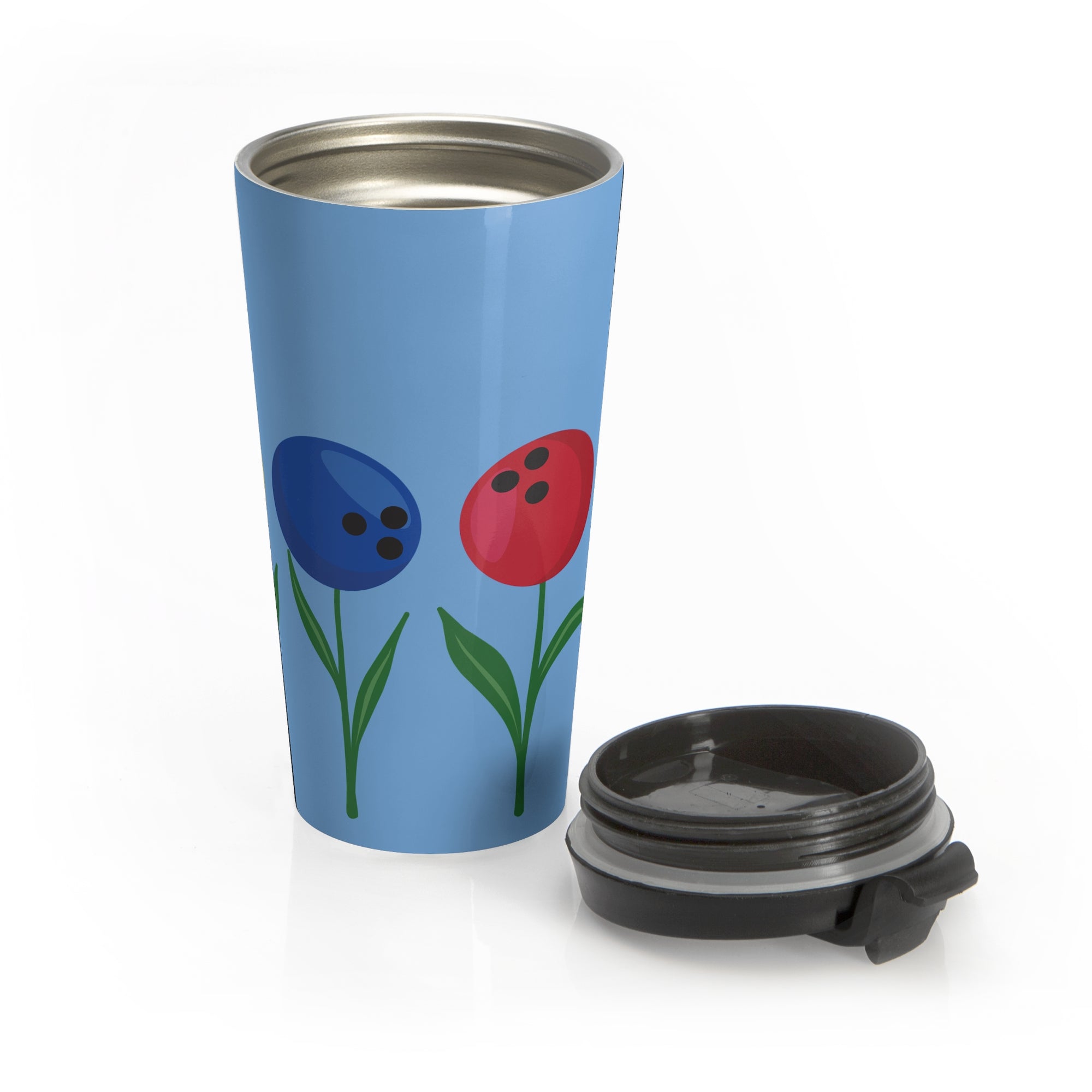 Light blue travel mug with a black lid next to the mug, with colorful flowers made out of bowling balls, on a white background