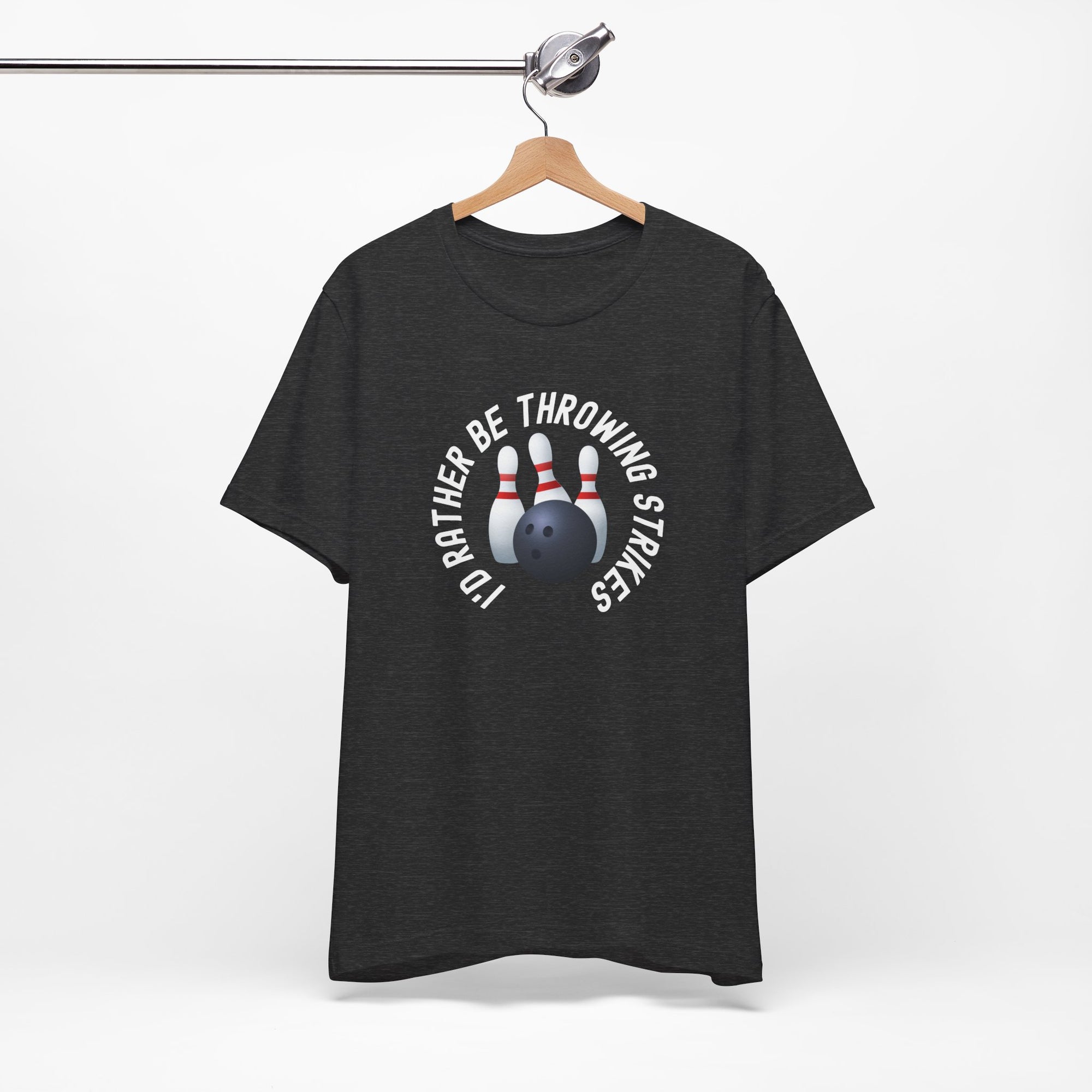 Dark gray t-shirt with bowling pins and a bowling ball and text saying "I'd Rather Be Throwing Strikes" on a hanger against a white background