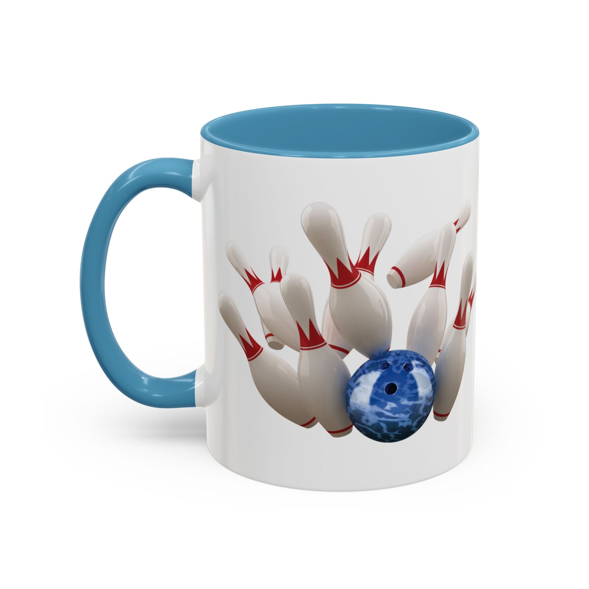 A white ceramic coffee mug with light blue accents on the handle and interior, with a graphic of a blue bowling ball knocking over bowling pins, on a white background